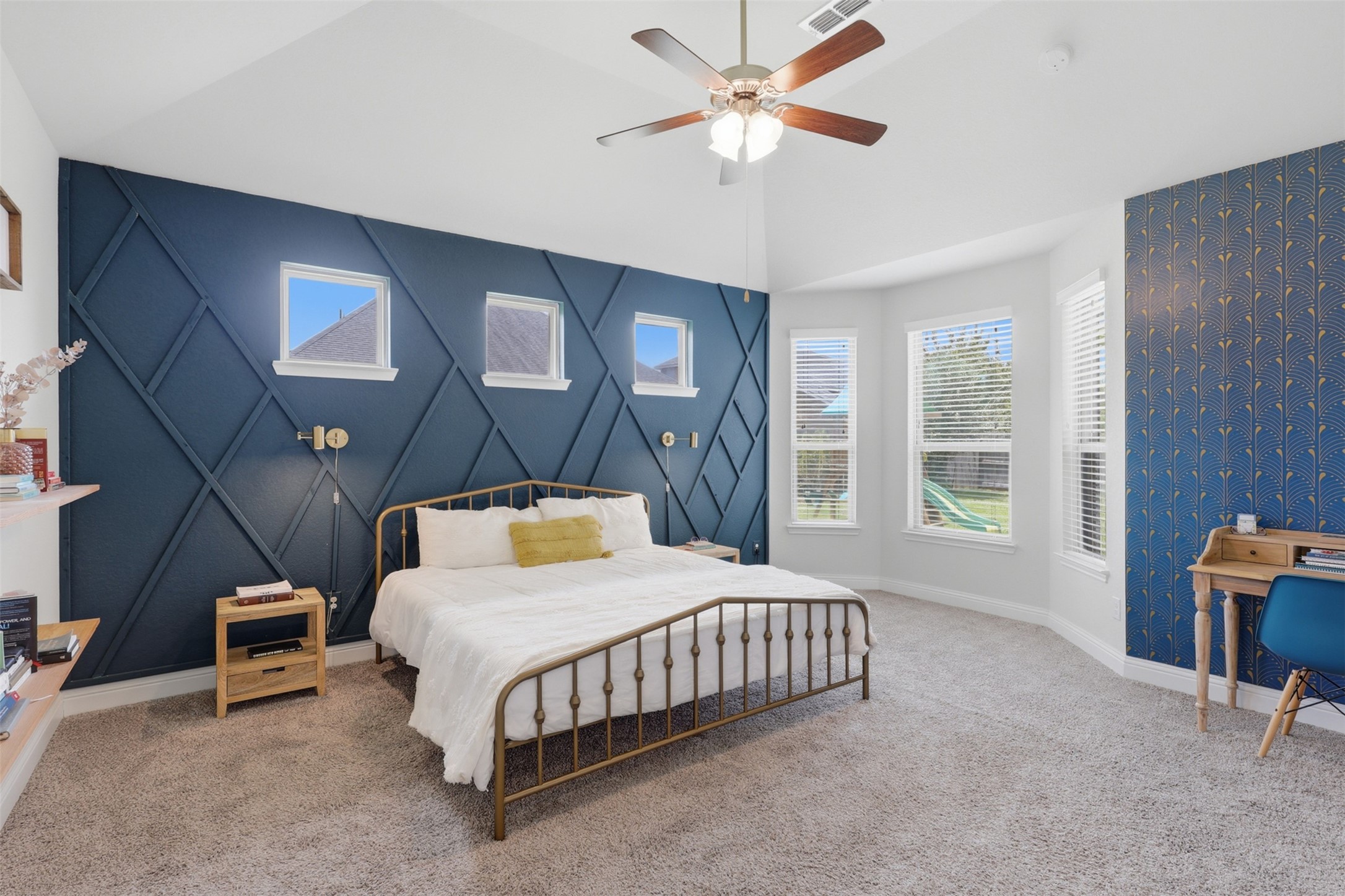 Generously sized primary suite with tray ceiling and abundant natural light.