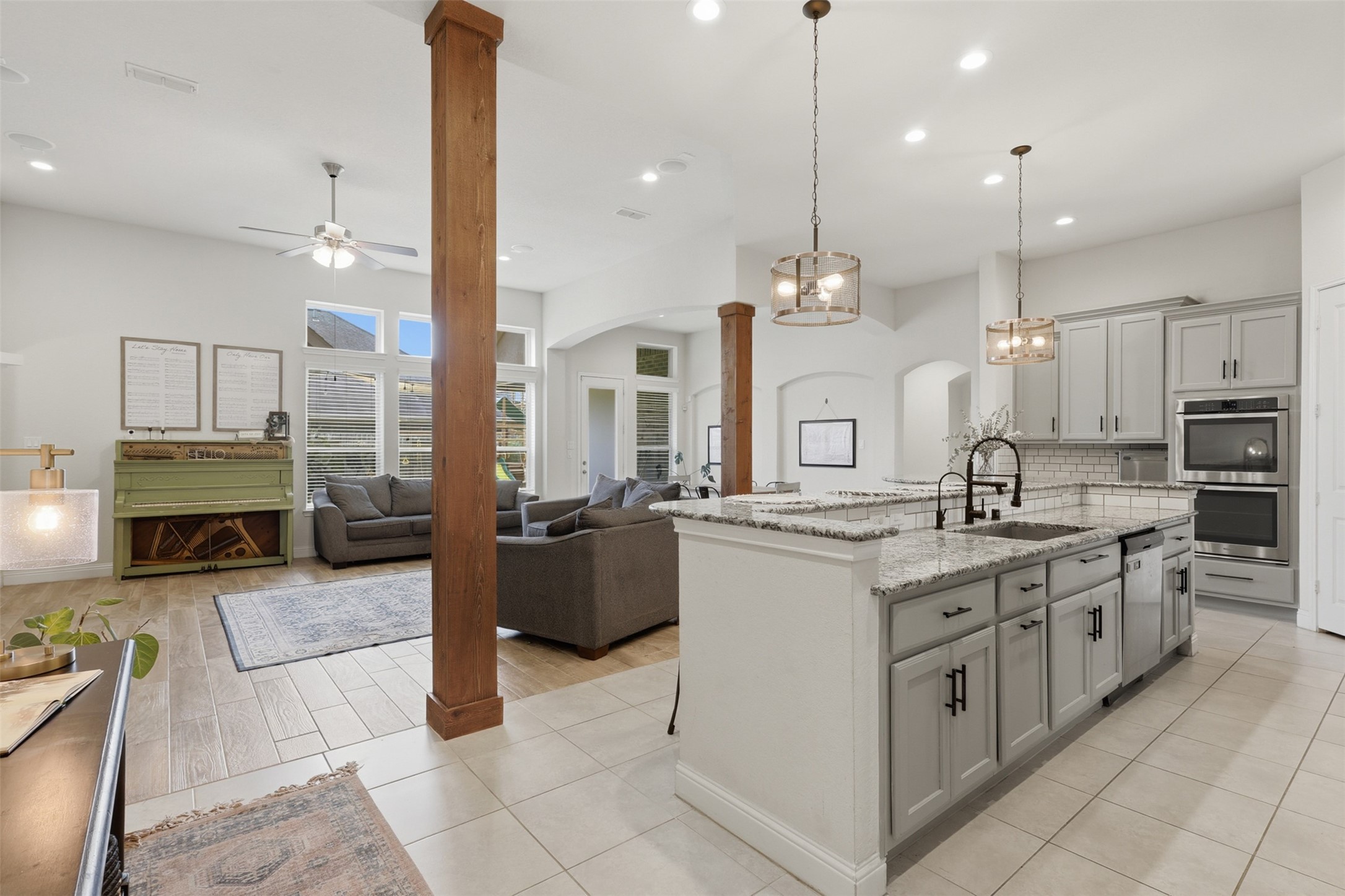 Spacious island kitchen with light countertops and stainless steel appliances.