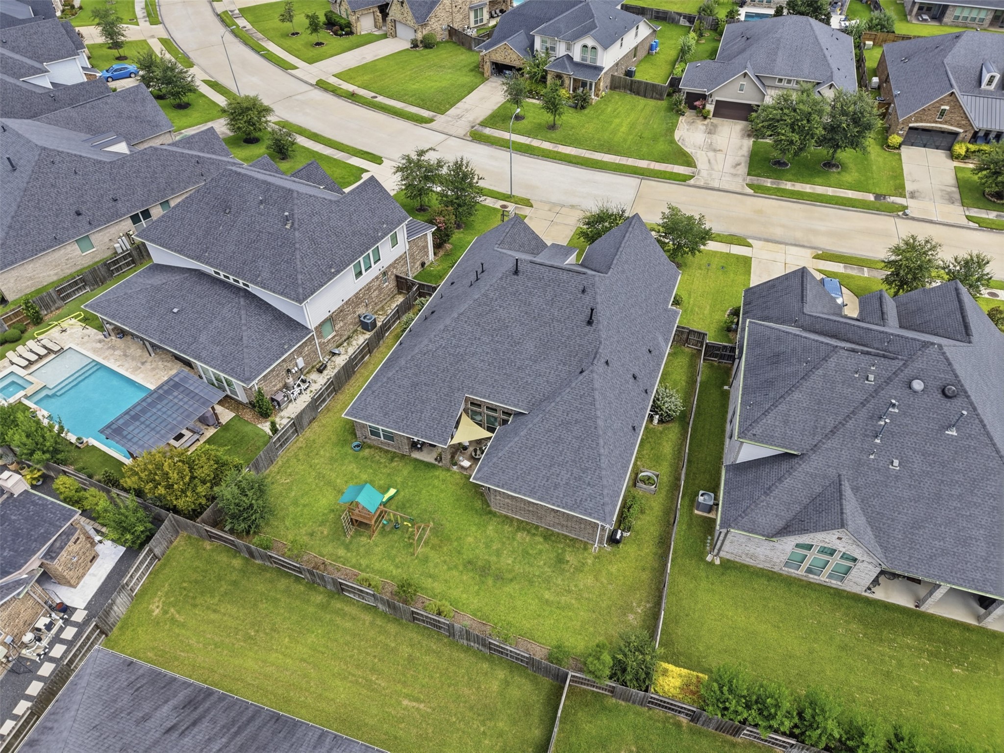 Rear elevation showcasing the covered patio and expansive yard.
