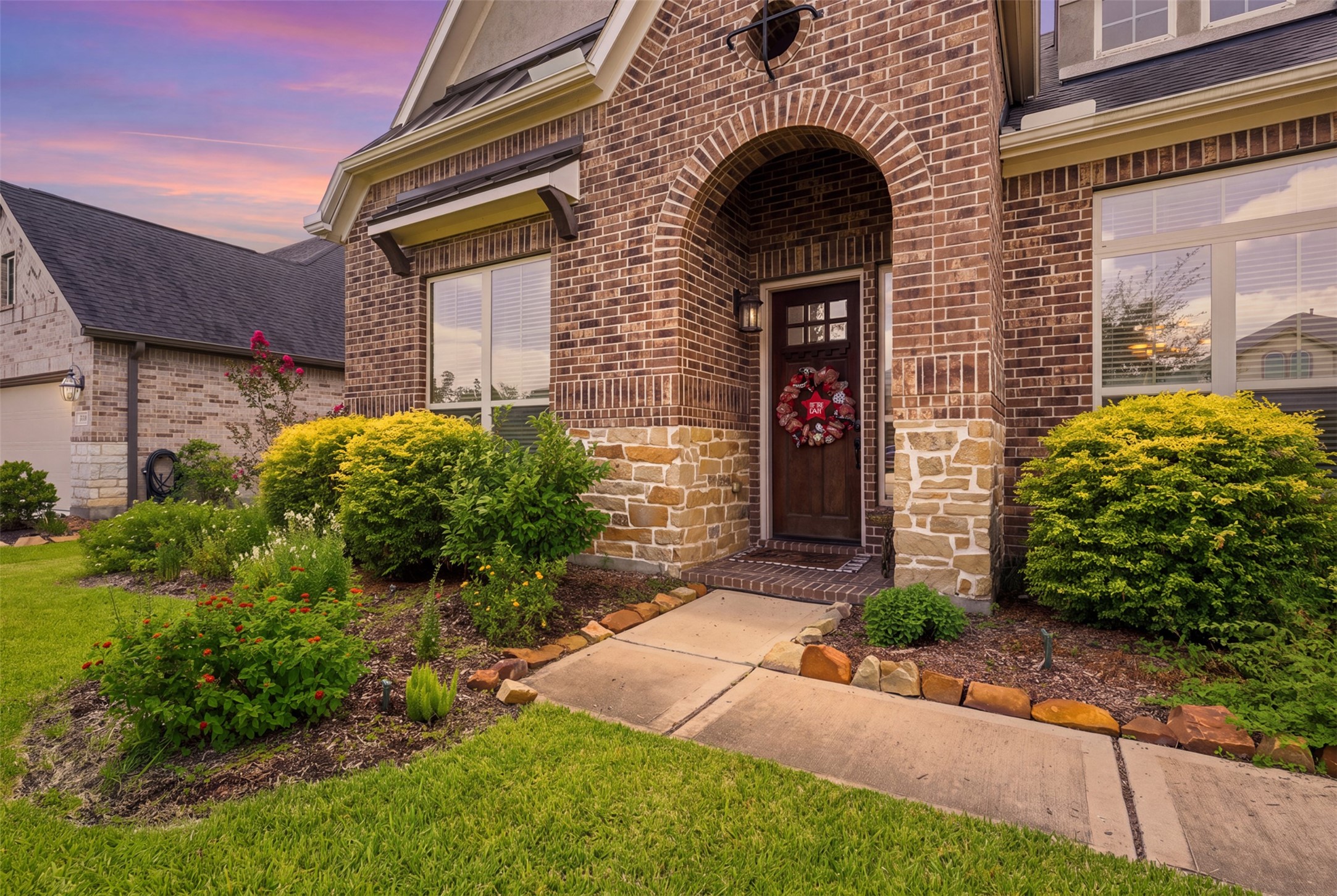 Covered front porch with elegant brick archway.
