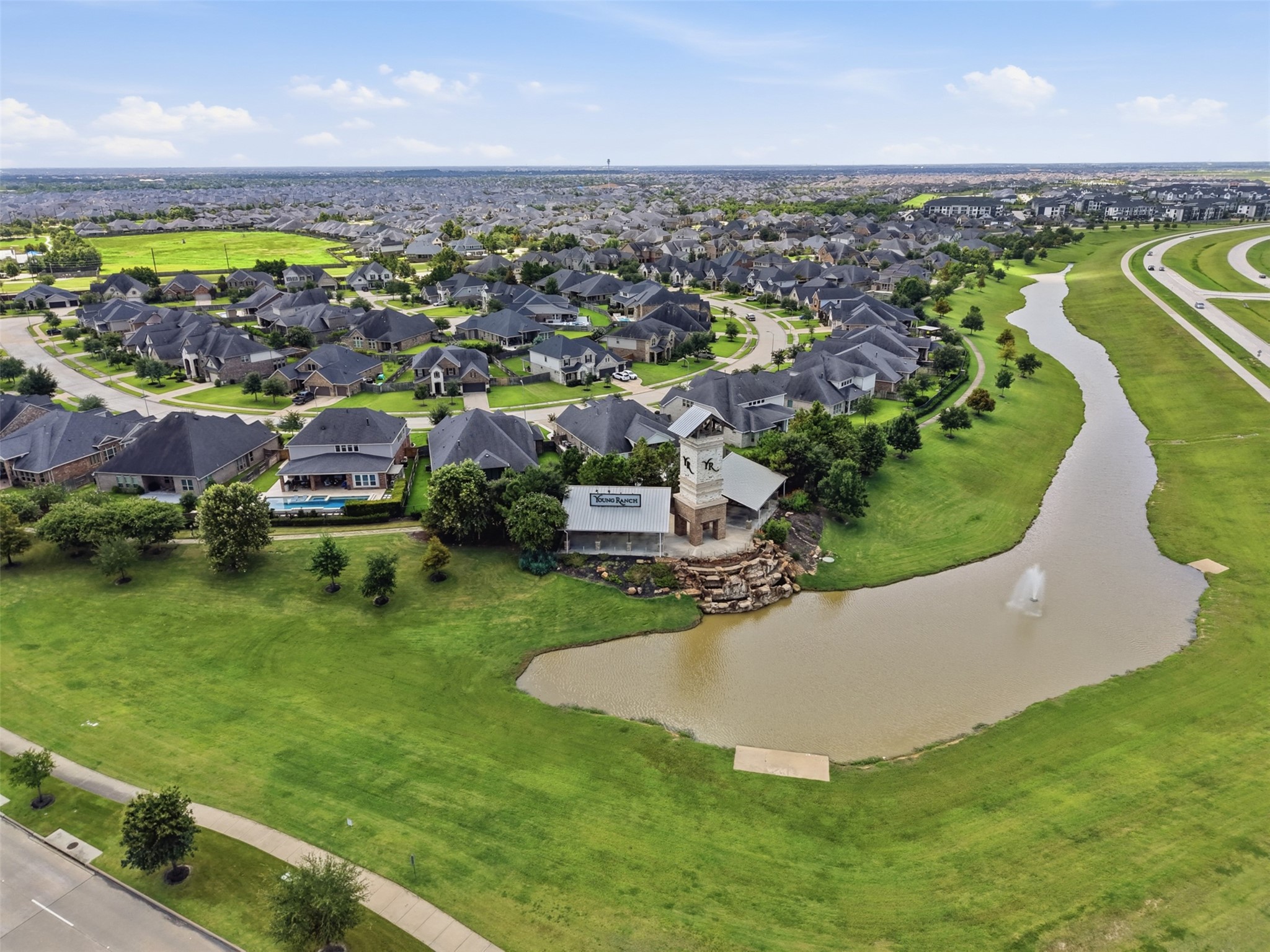 Neighborhood aerial showcasing nearby homes and green space.