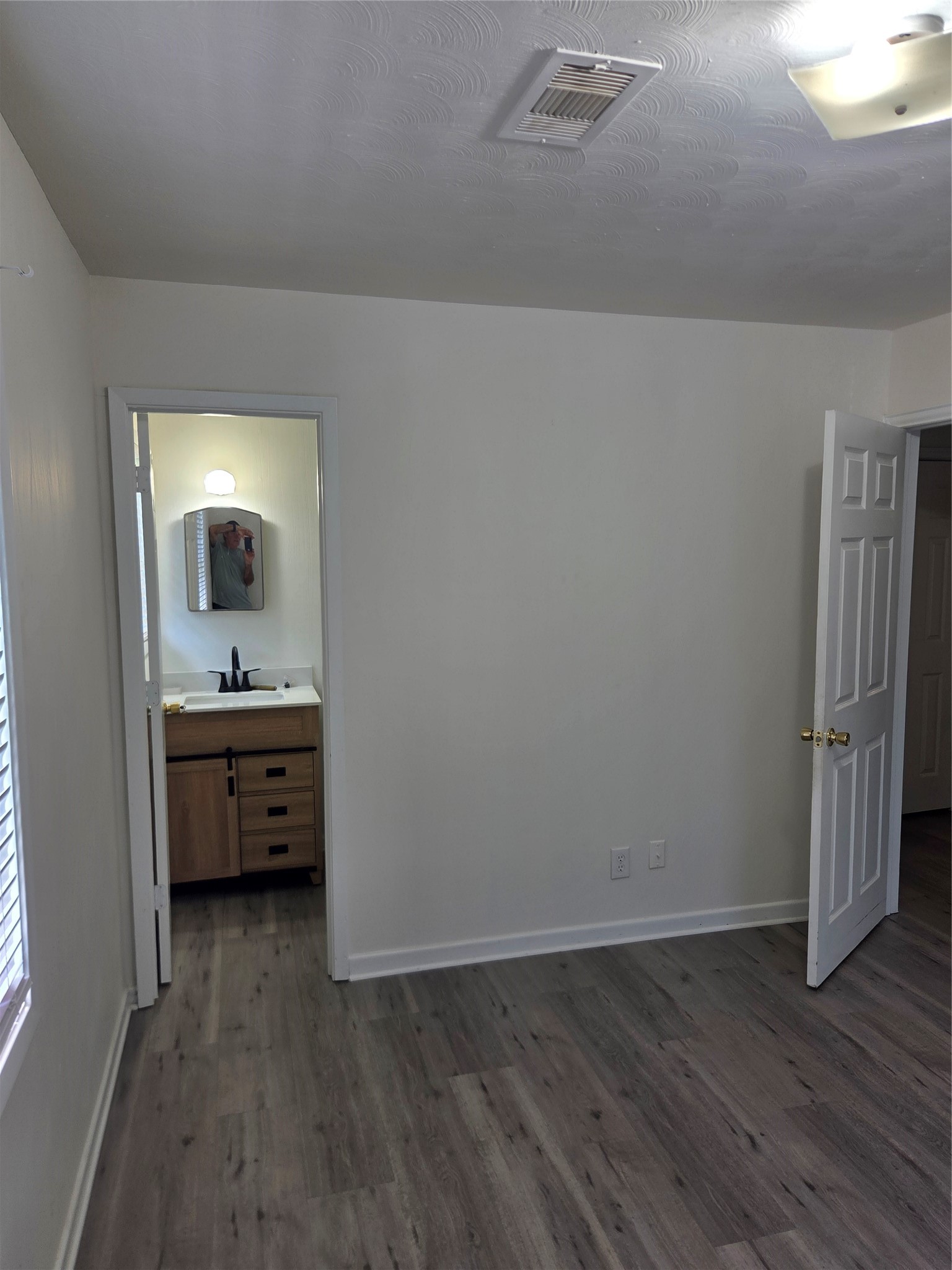 Primary bedroom has private half bath