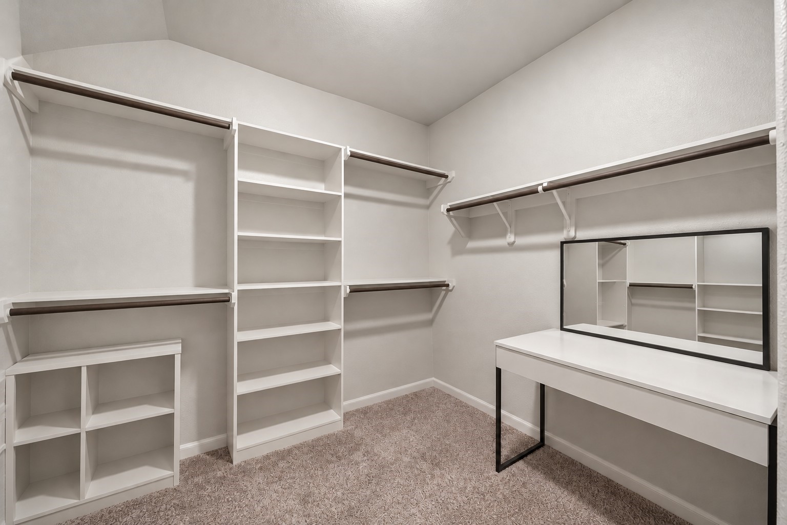 Virtually Enhanced: This spacious walk-in primary closet features a functional layout with generous storage capacity and an open, accessible design. Multiple walls offer built-in shelving and hanging rods at varying heights, providing ample space for clothing, shoes, and accessories.