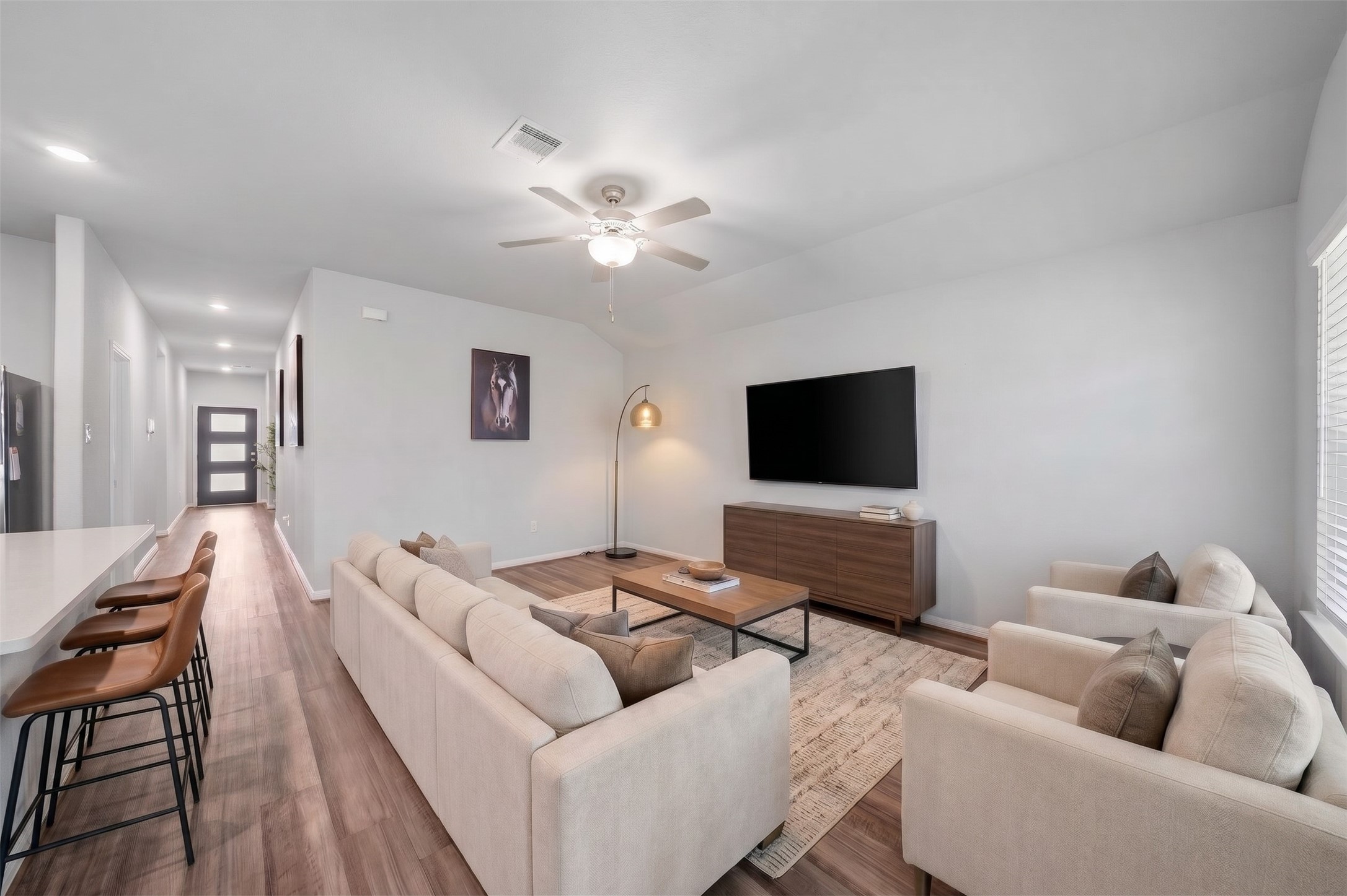 Virtually Staged: The living room features an open-concept layout with beautiful flooring, soft neutral walls, and a vaulted ceiling that enhances the rooms bright, airy atmosphere. Virtually Staged: The living room features an open-concept layout with beautiful flooring, soft neutral walls, and a vaulted ceiling that enhances the rooms bright, airy atmosphere.
