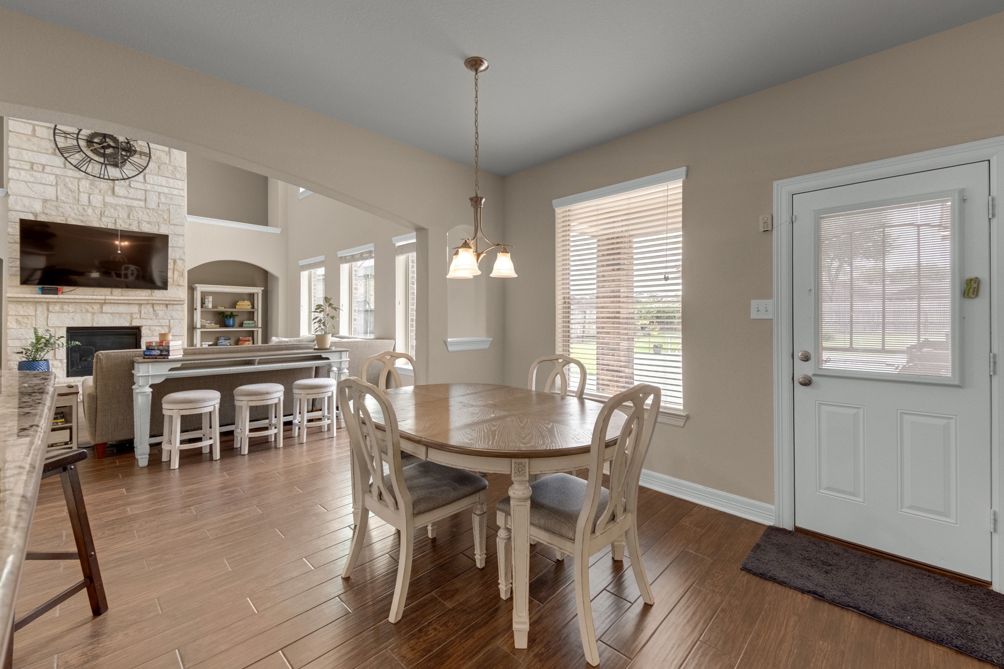 The breakfast room sits in a bright corner with a window bank over the backyard and a door to the patio - the everyday counterpart to the formal dining room.