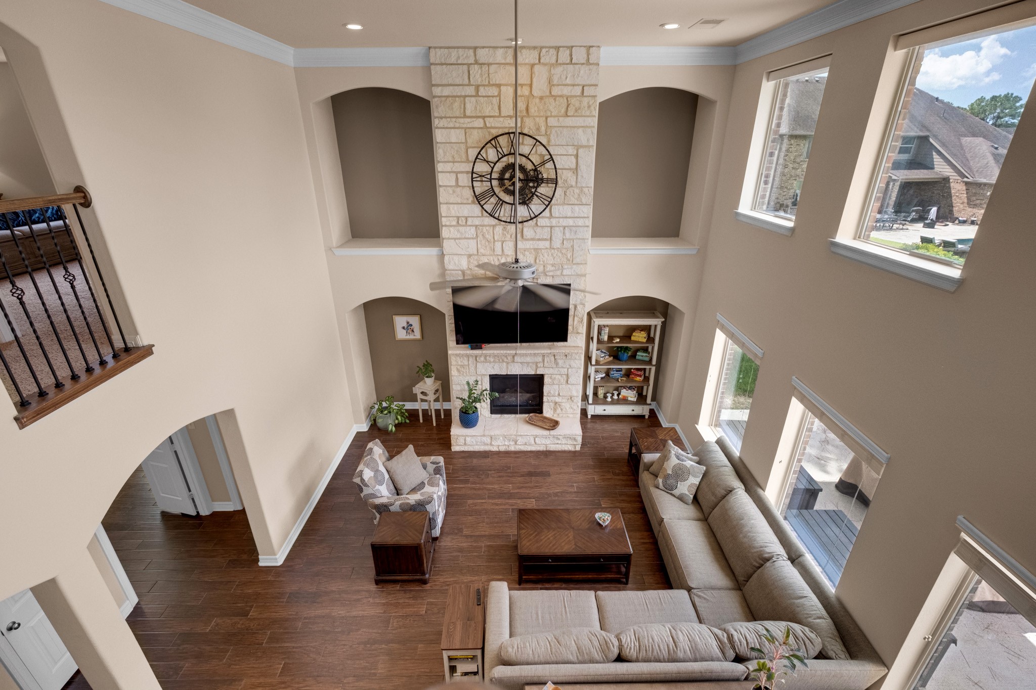 The second-floor landing looks down over the entire family room, showing how the arches, niches, and light bank all line up.