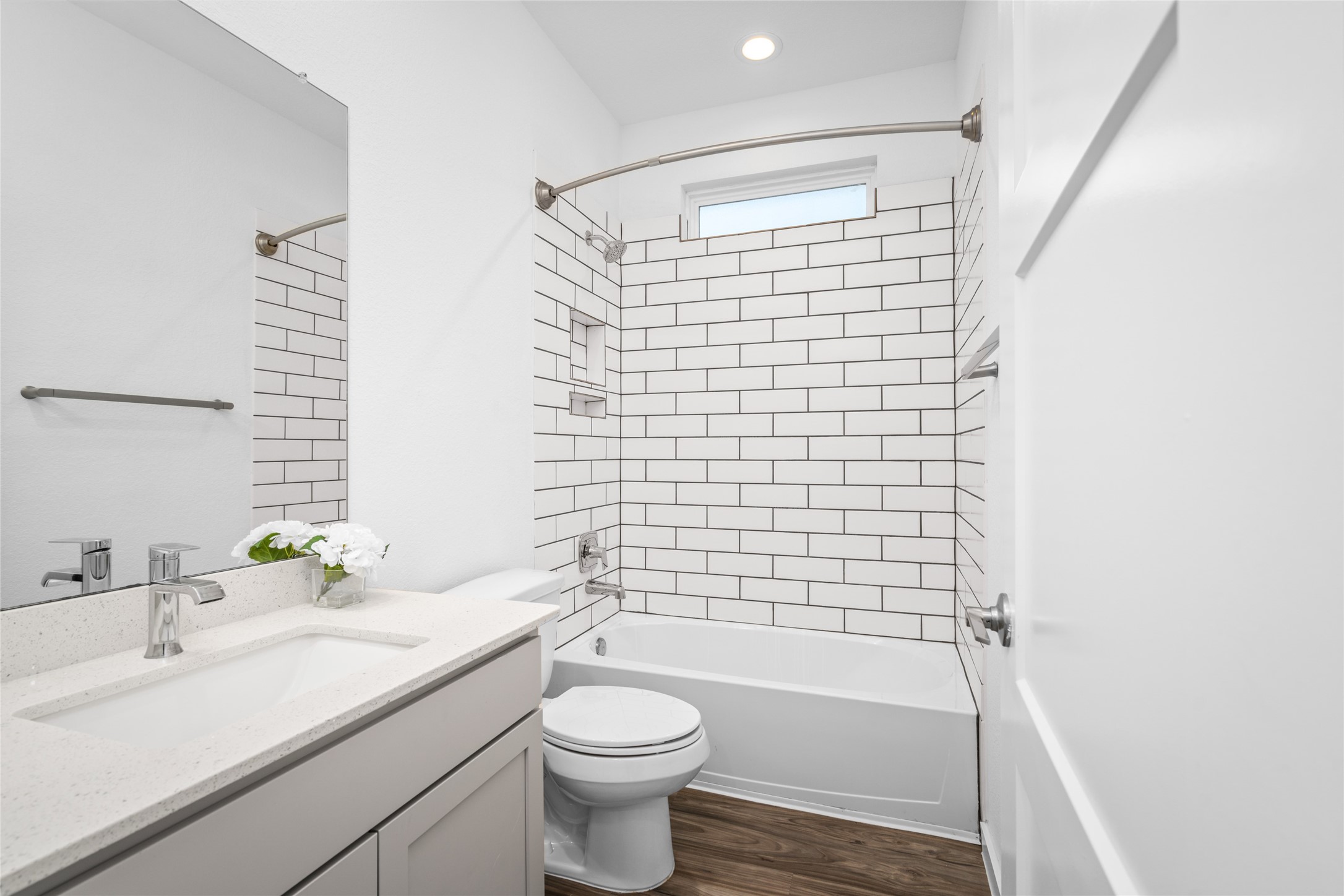 Secondary bathroom with subway tile and tub/shower combo.
