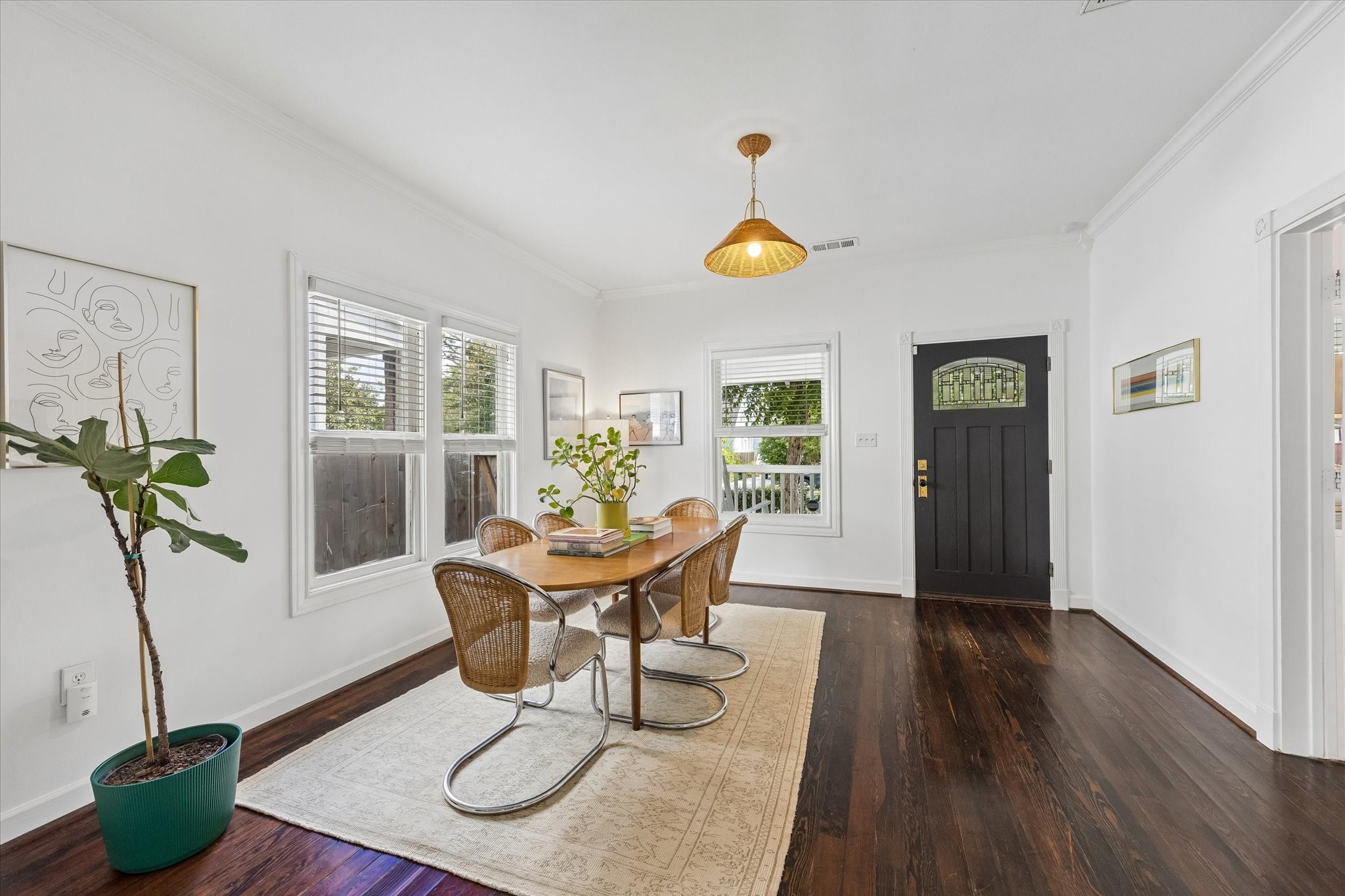 The front room, currently being used as a dining room is spacious and contains a beautiful light fixture