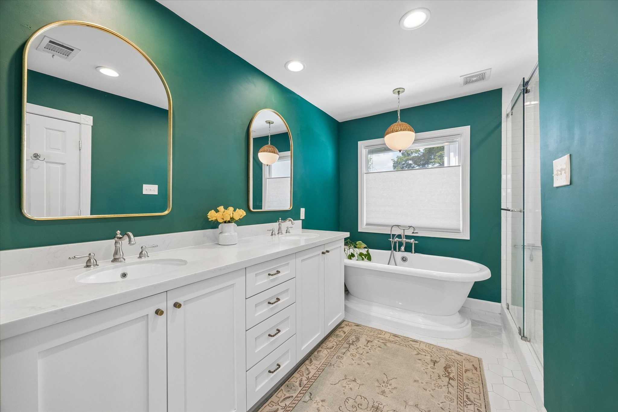 Primary bathroom with double sinks, soaking tub, separate shower and private water closet