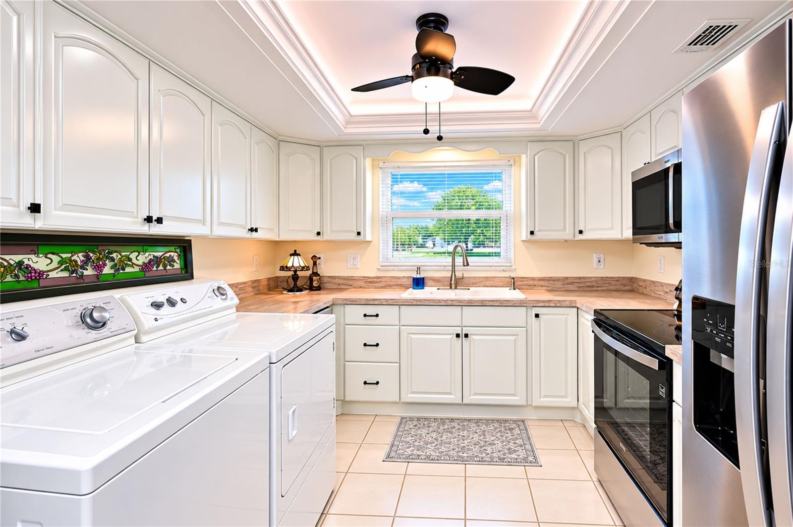 White cabinetry is complimented by the tray ceiling with remote controlled LED lighting
