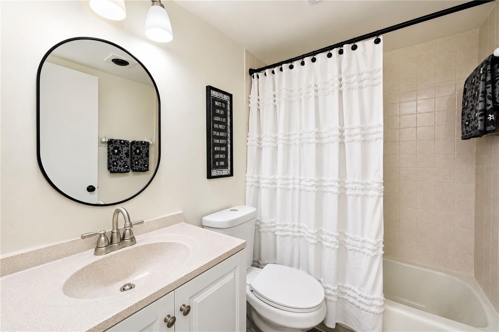 The adjacent secondary bathroom is nicely updated