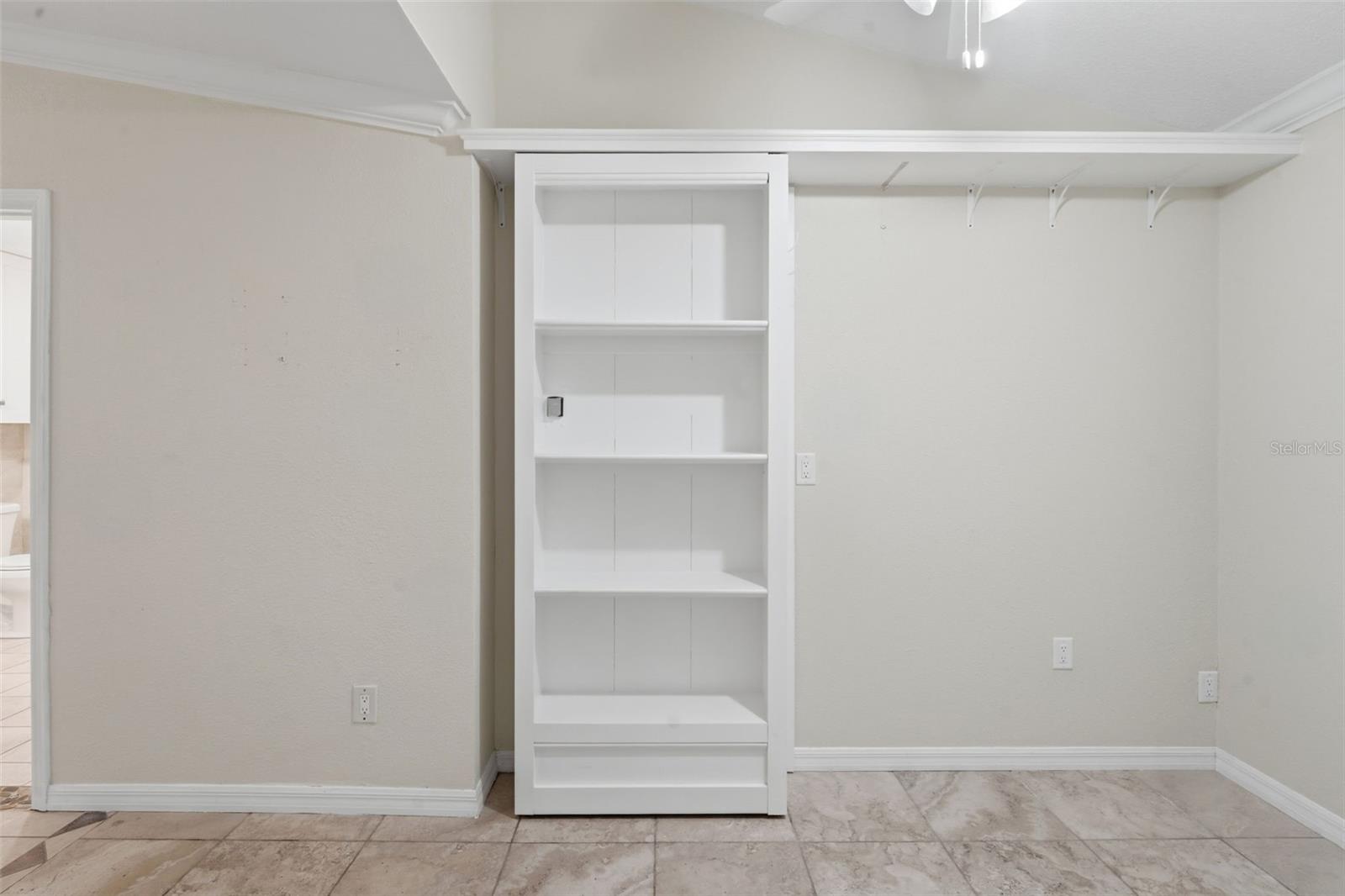 Shelf door to safe room