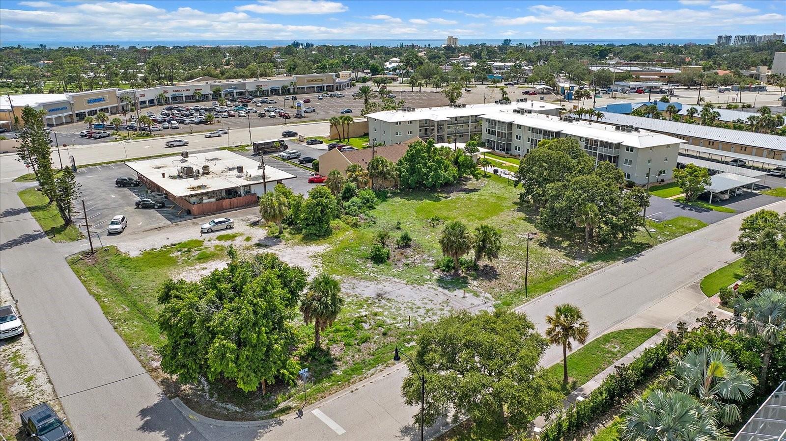 Aerial view of the lot facing the shopping plaza and nearby condominiums Aerial view of the lot facing the shopping plaza and nearby condominiums