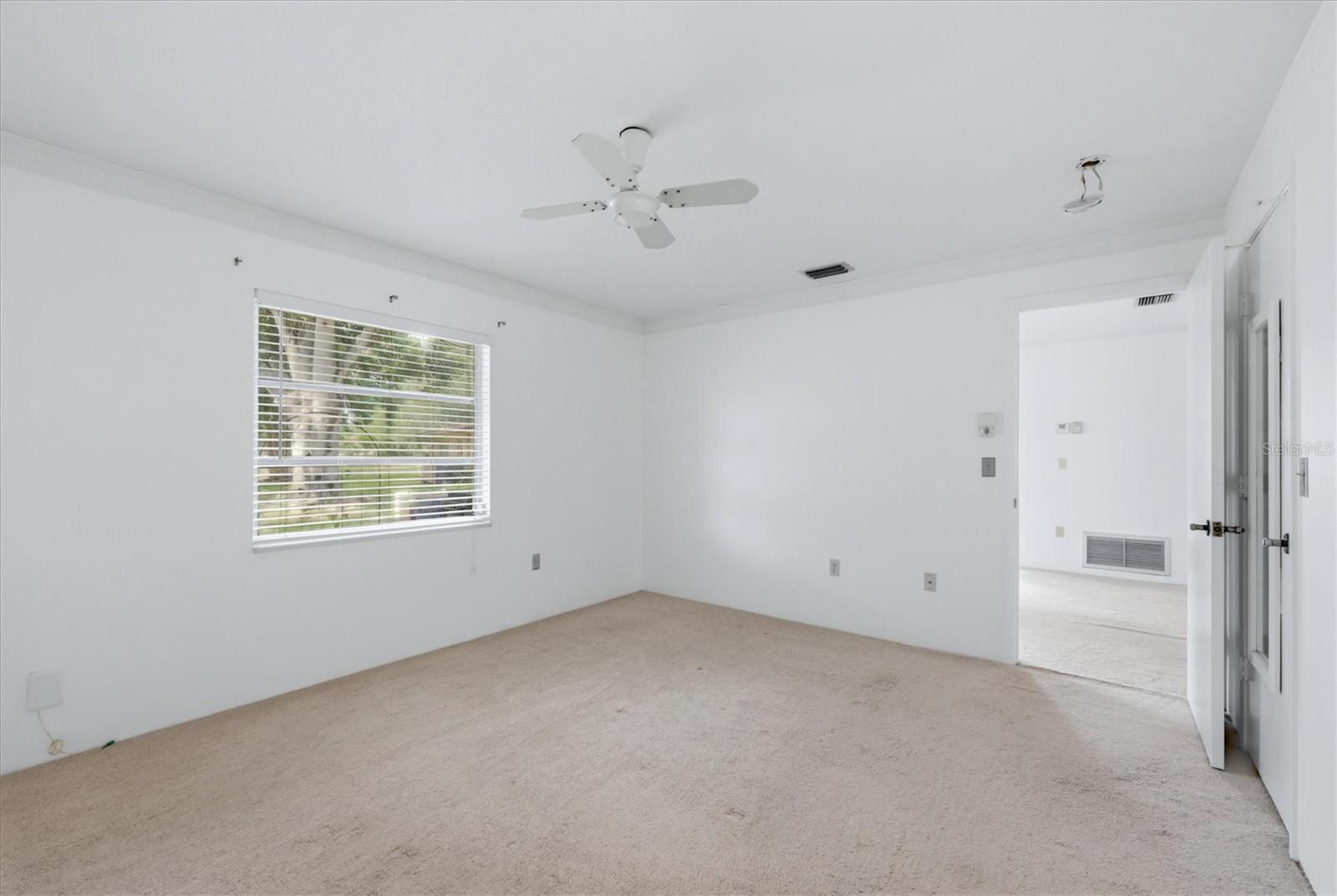 Primary bedroom faces peaceful backyard