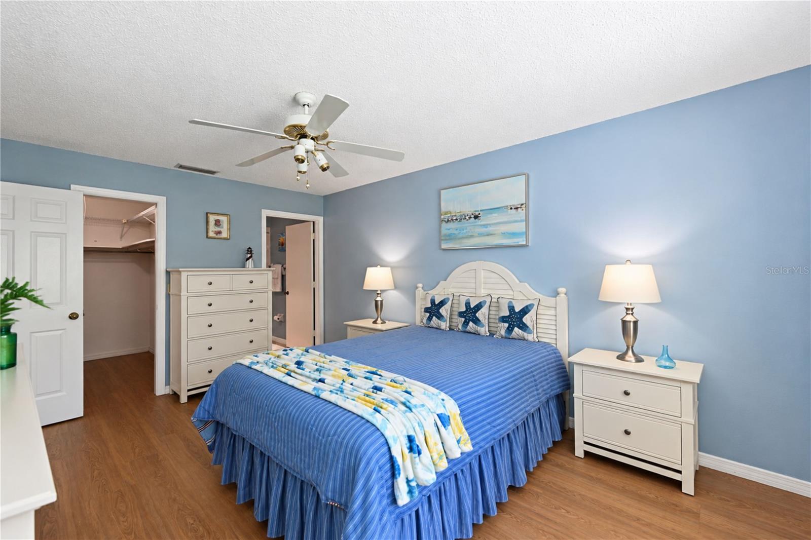 Primary bedroom to walk-in closet and ensuite bathroom