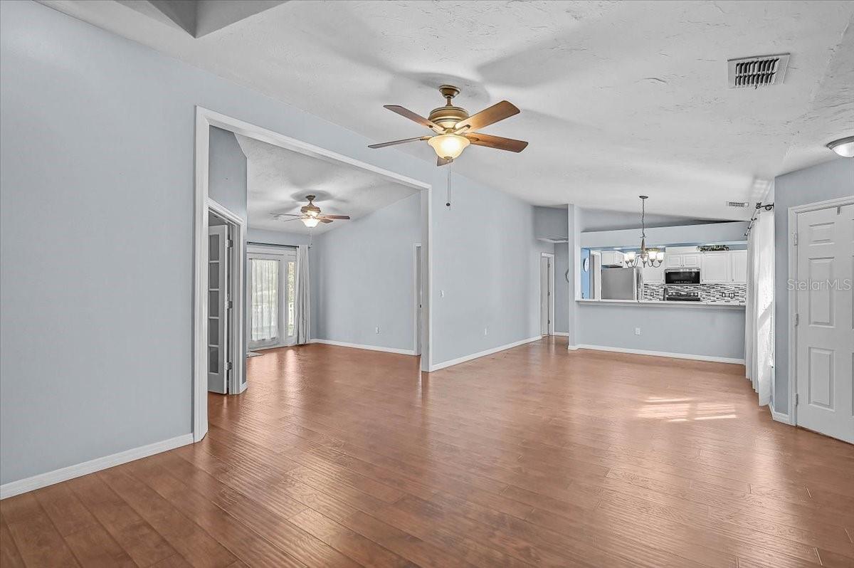 Living Room, Dining Room, Kitchen, Den with Double French Doors, Open Bonus Room to Exterior French Doors to Back Patio and Pond.