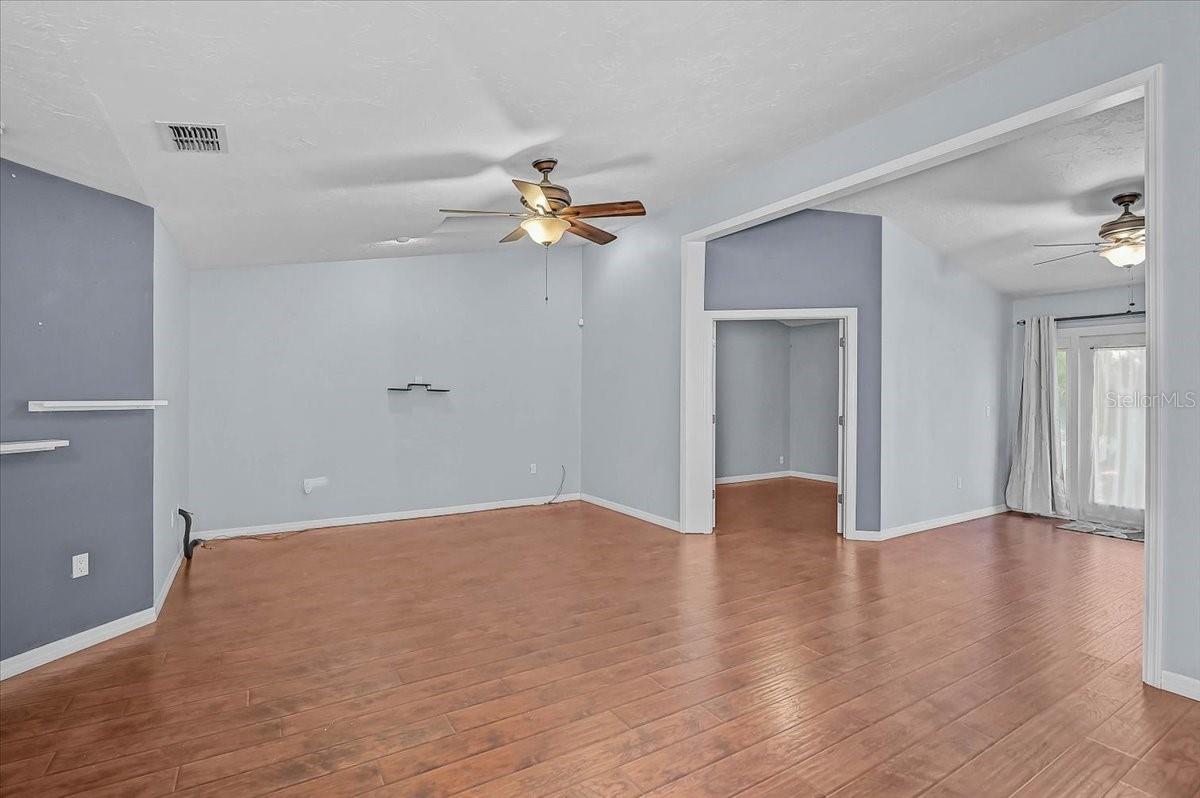 Living Room, Den with Double French Doors, Open Bonus Room to Exterior French Doors to Back Patio and Pond.