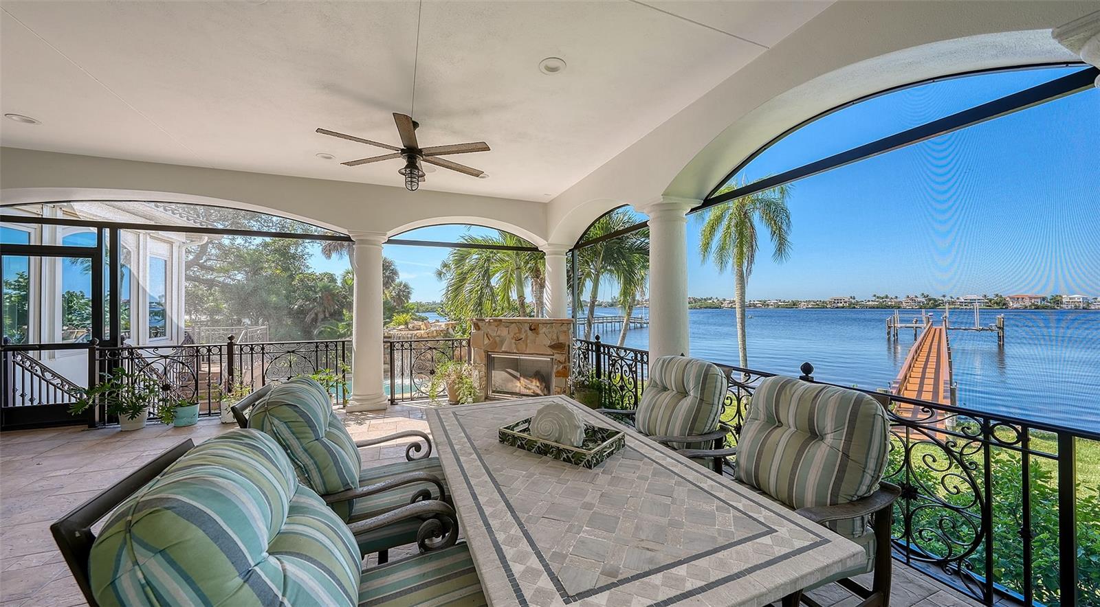 stunning view of the water and dock and the pool area