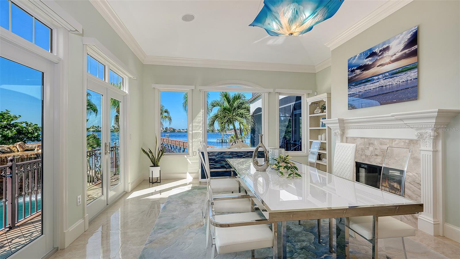 formal dining room with walls of windows to the water
