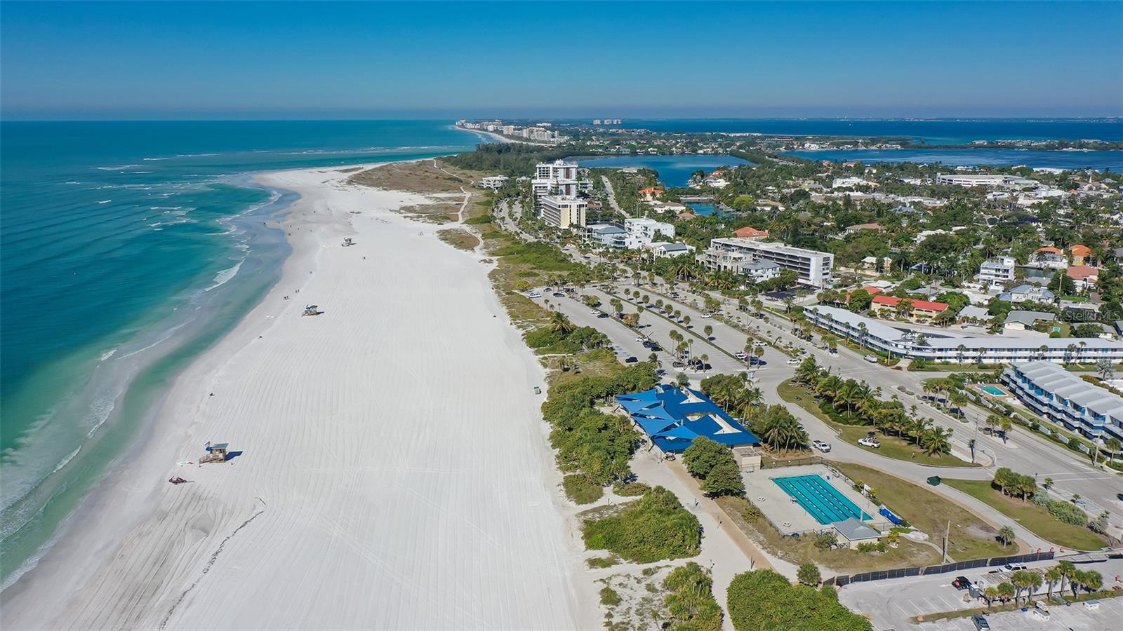 A breathtaking aerial view of Lido Beach, showcasing pristine white sands and brilliant turquoise waters along Sarasotas stunning Gulf Coast.
