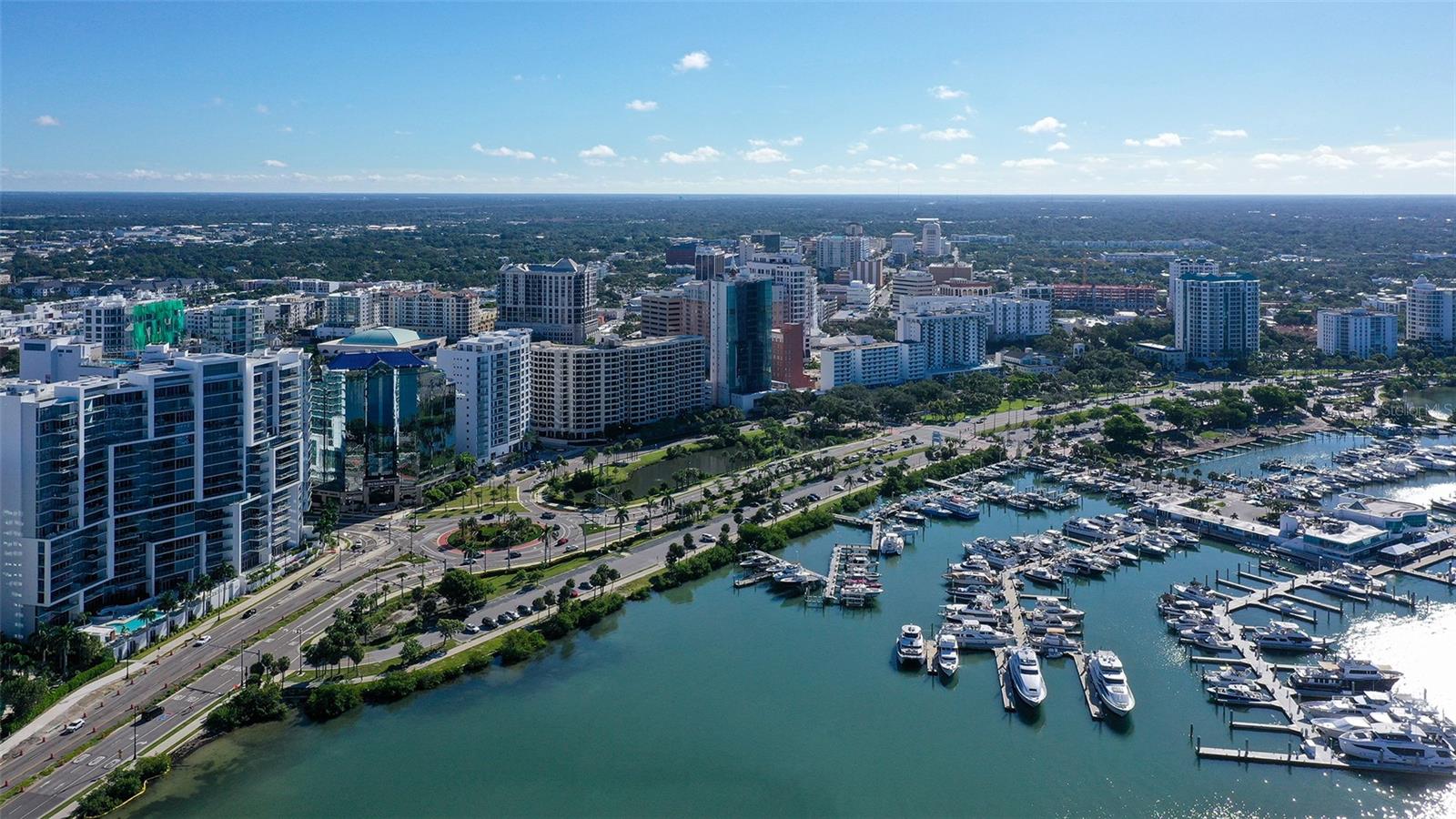 Aerial views capture The VUEs striking waterfront presence against Sarasotas vibrant downtown skyline.
