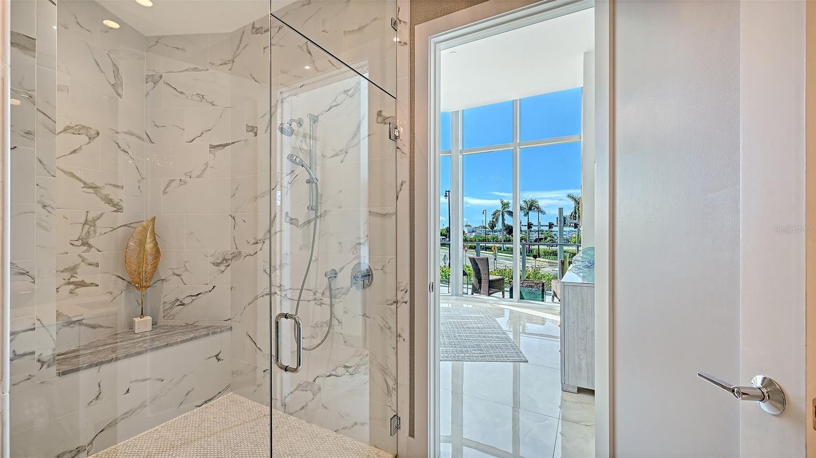 A luxurious, oversized walk-in shower enclosed in sleek glass, offering a spa-inspired bathing experience.