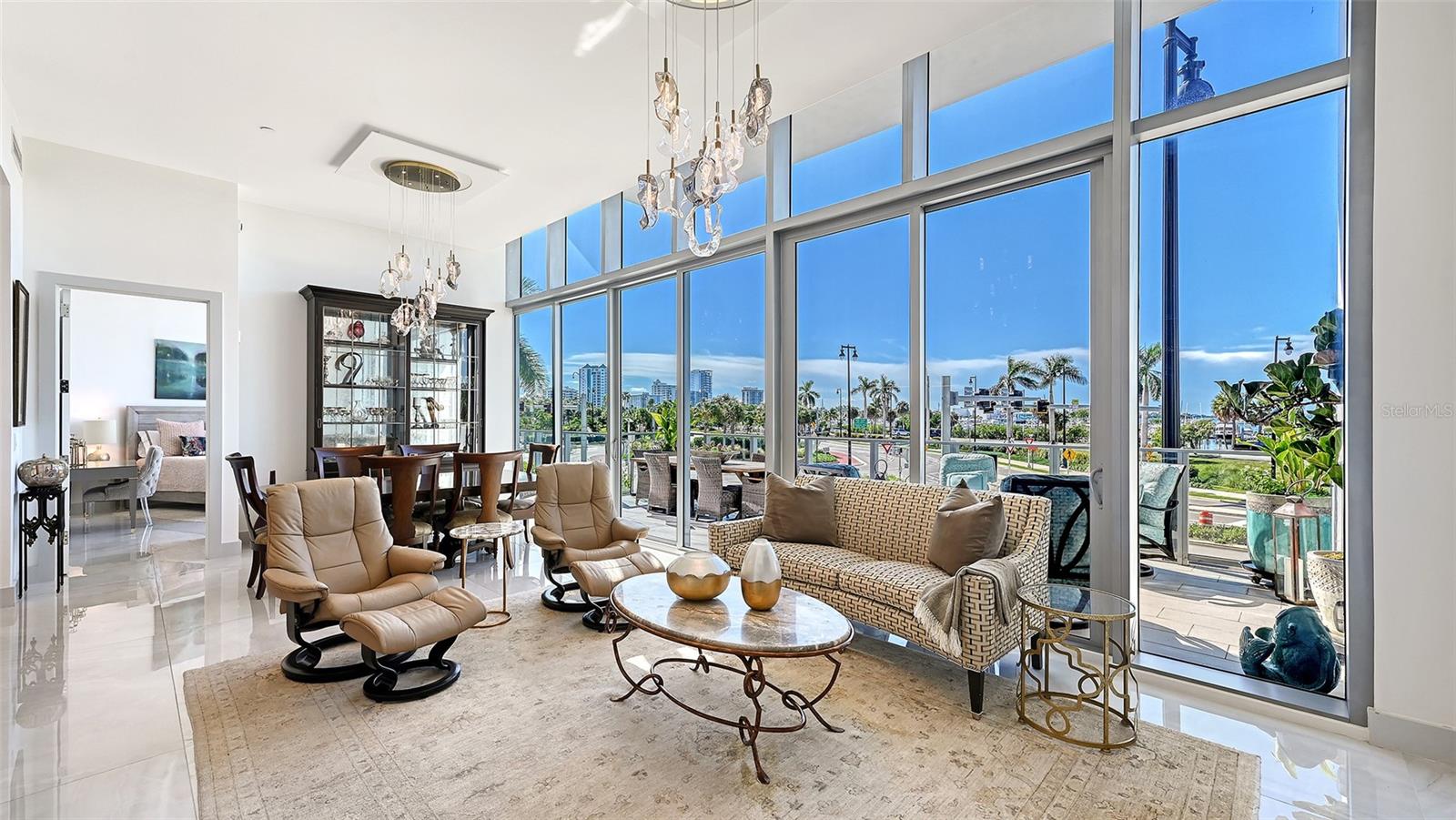 A sun-drenched, open-concept living space that flows seamlessly onto a private 533-square-foot balcony, showcasing spectacular panoramic waterfront views.