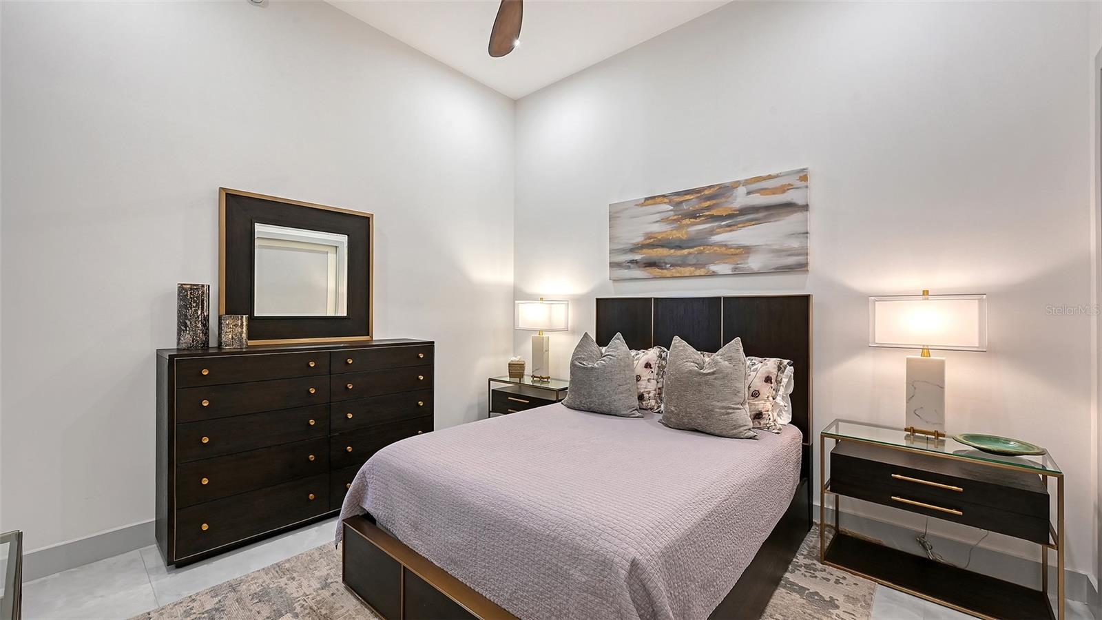 A spacious second bedroom featuring impressive 12-foot ceilings and an airy, open feel.