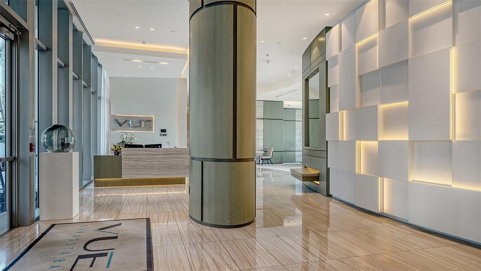 Welcome to The VUE, where a grand lobby with soaring ceilings creates an impressive first impression of luxury and sophistication.