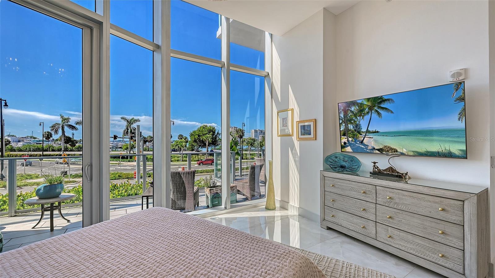A light-filled primary suite with soaring ceilings, elegant finishes, and a serene, airy ambiance.