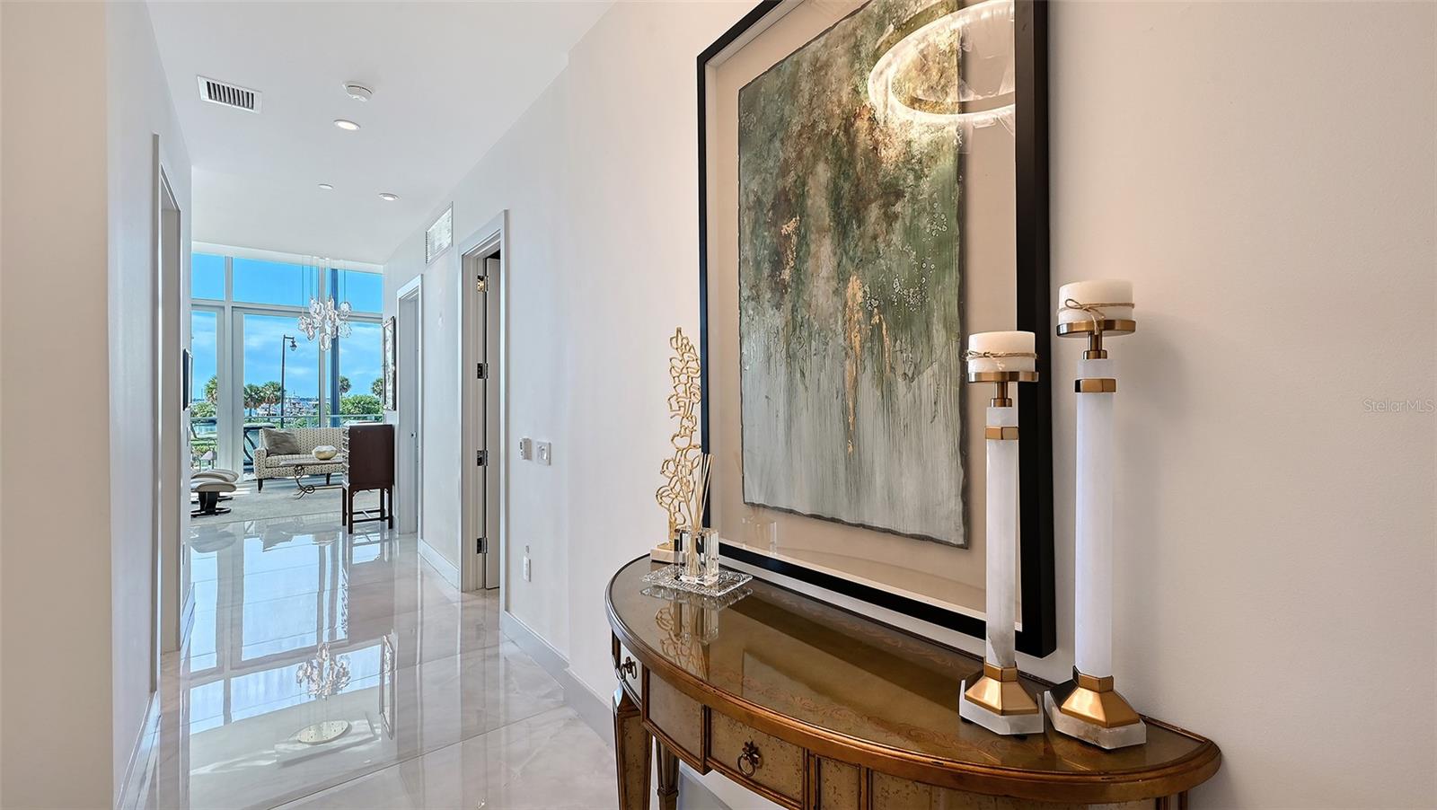 Step into a welcoming foyer with breathtaking views of Sarasota Bay unfolding directly ahead.