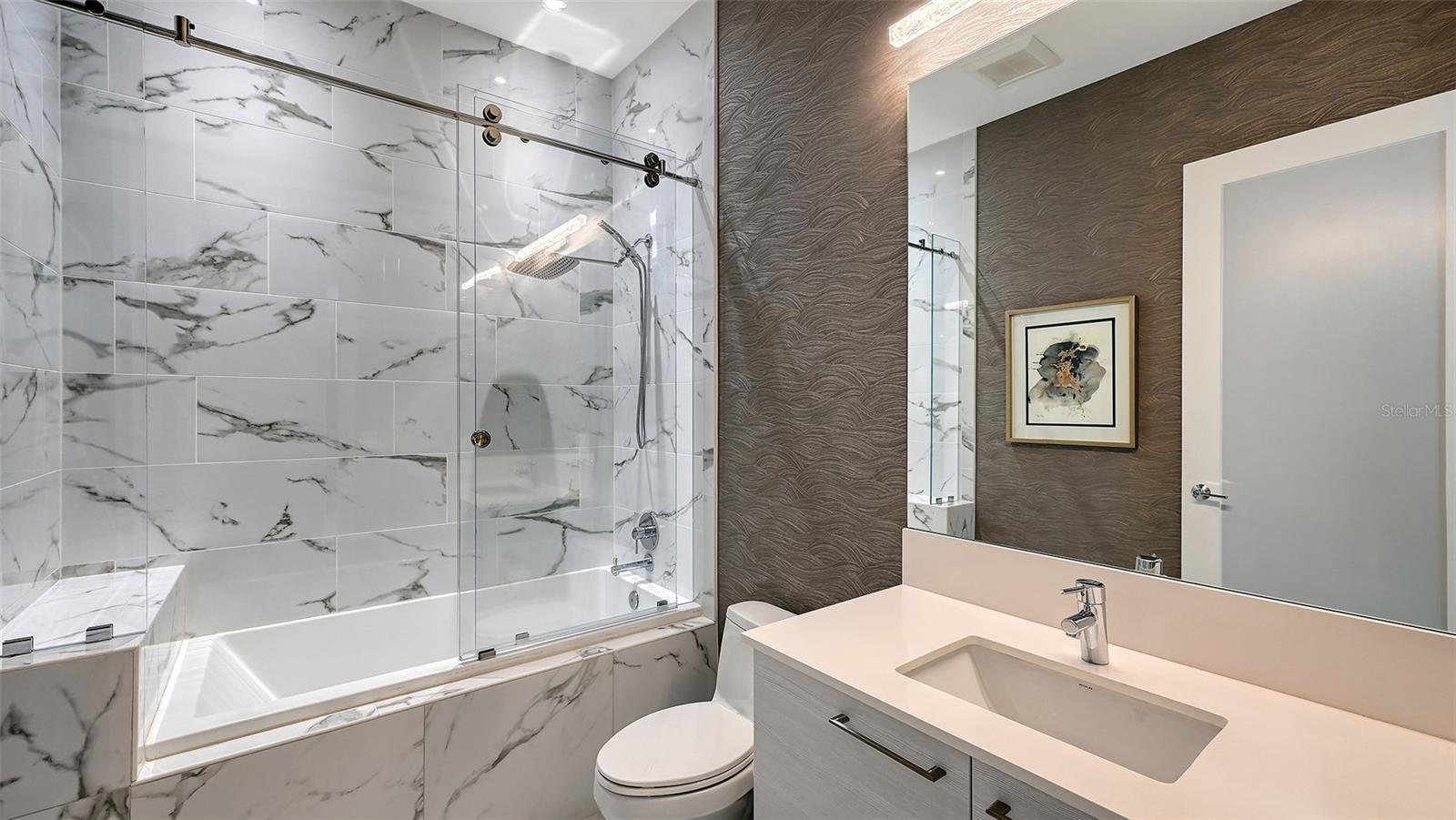A luxurious, oversized walk-in shower enclosed in sleek glass, offering a spa-inspired bathing experience.