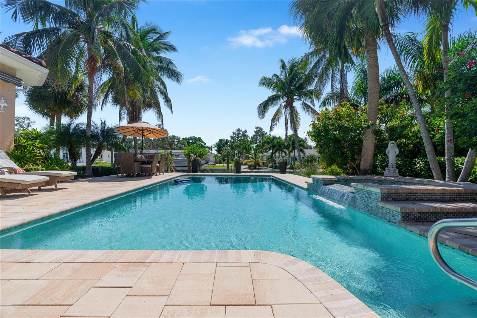 Resort-style pool and spa surrounded by mature palms create a private setting for enjoying the Florida sunshine.