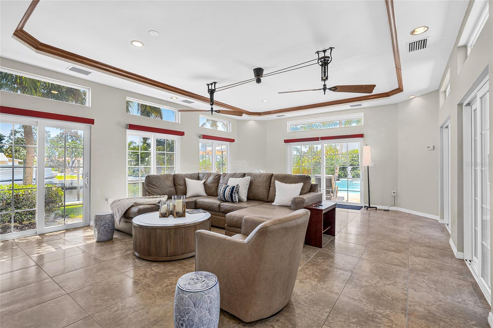 Spacious flex room features tall ceilings, abundant natural light and easy access to the outdoor living areas.