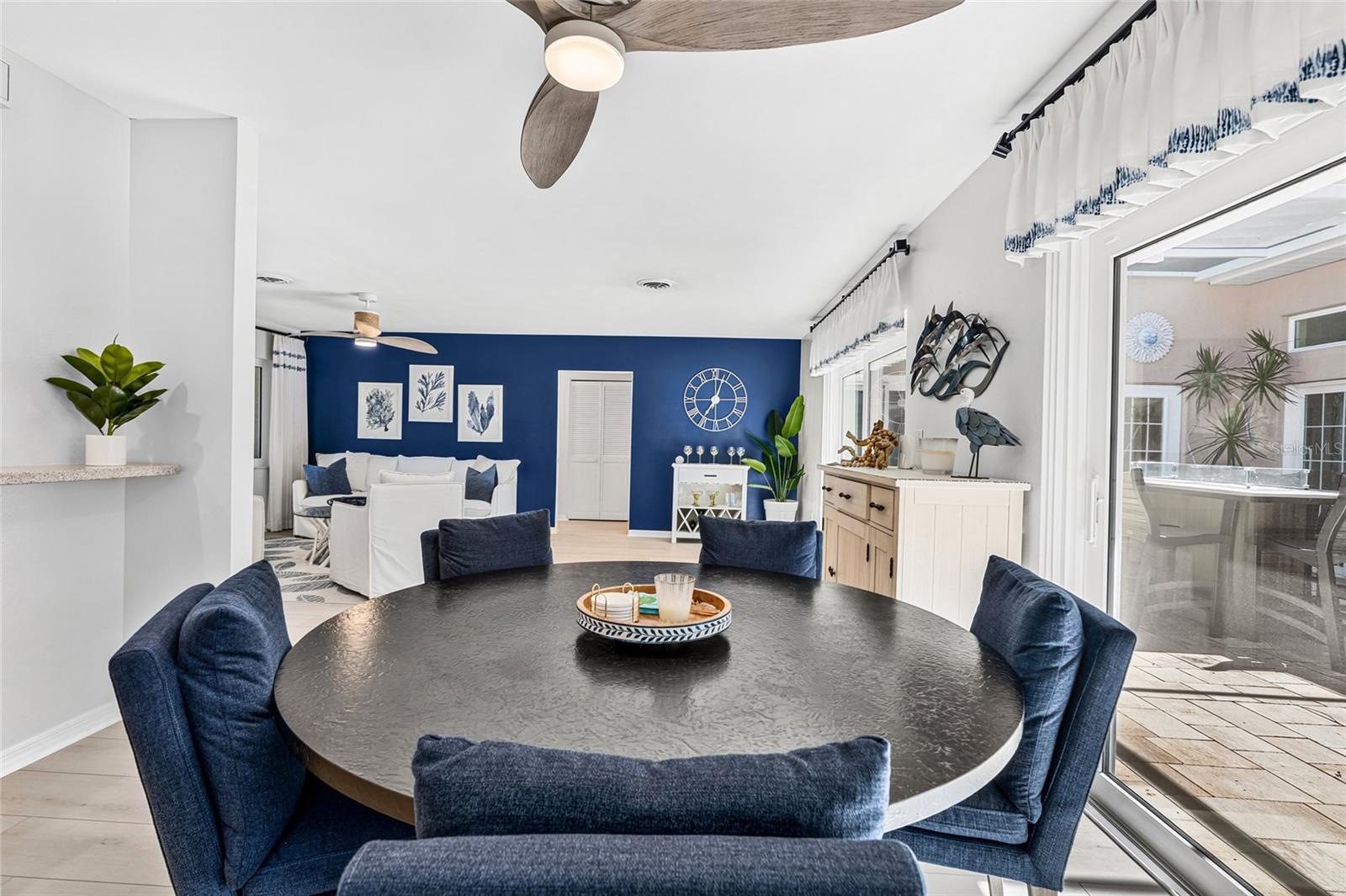 Dining area overlooks the screened courtyard lanai, creating an easy connection between indoor and outdoor living.