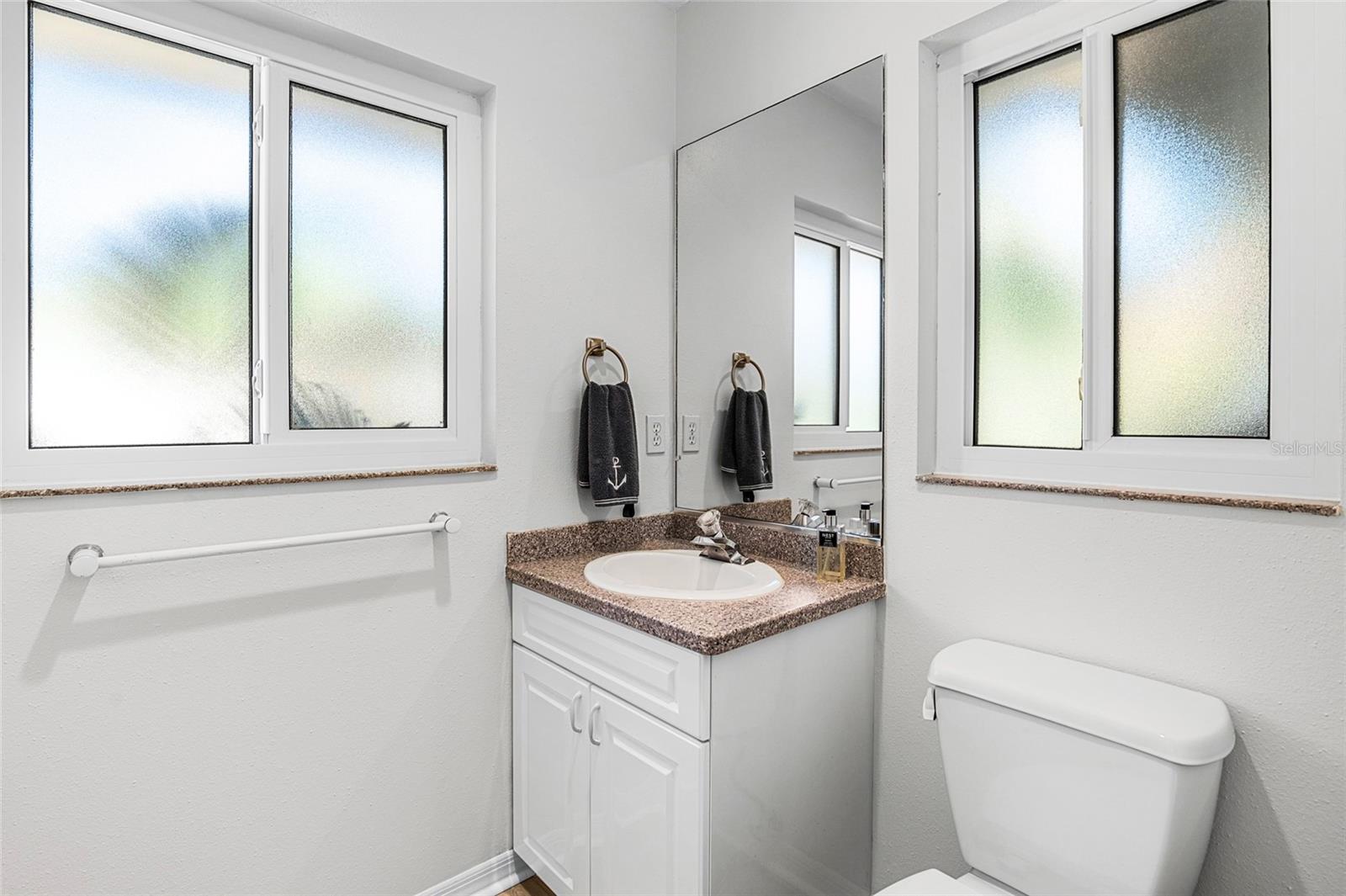 Convenient powder room serves the main living areas.