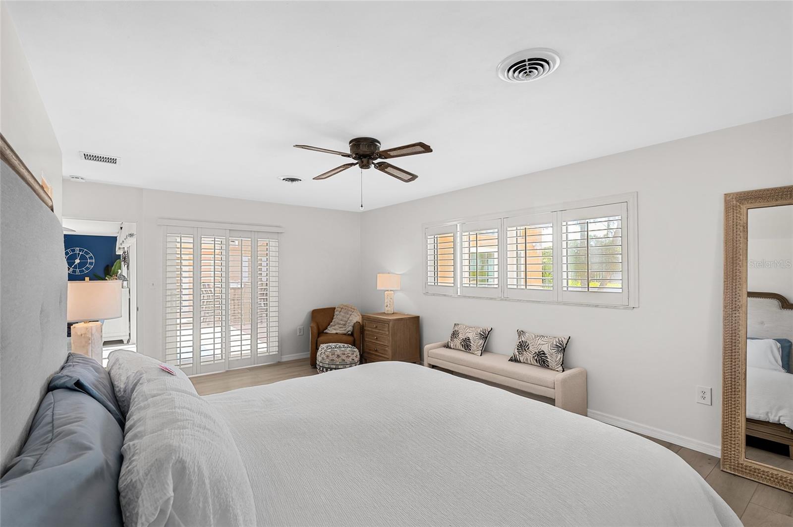 The first floor primary suite offers comfortable proportions, direct courtyard access and two walk in closets.