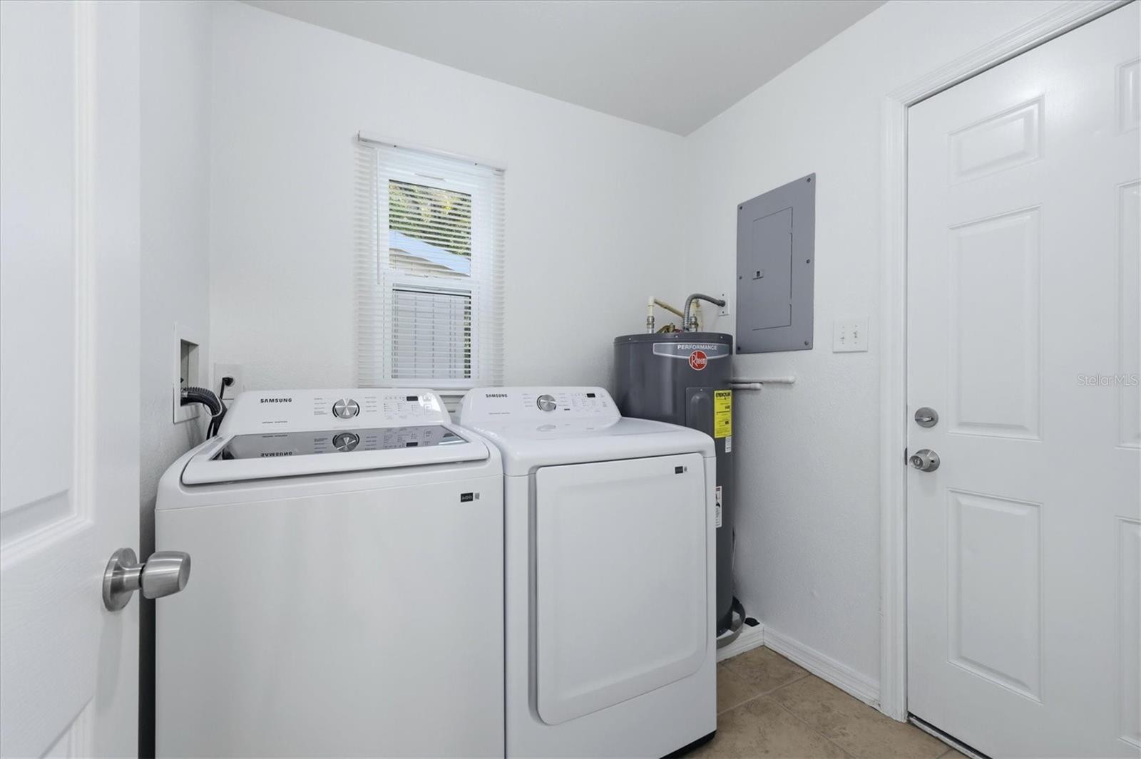 New washer and dryer in laundry room. Access door to the backyard.