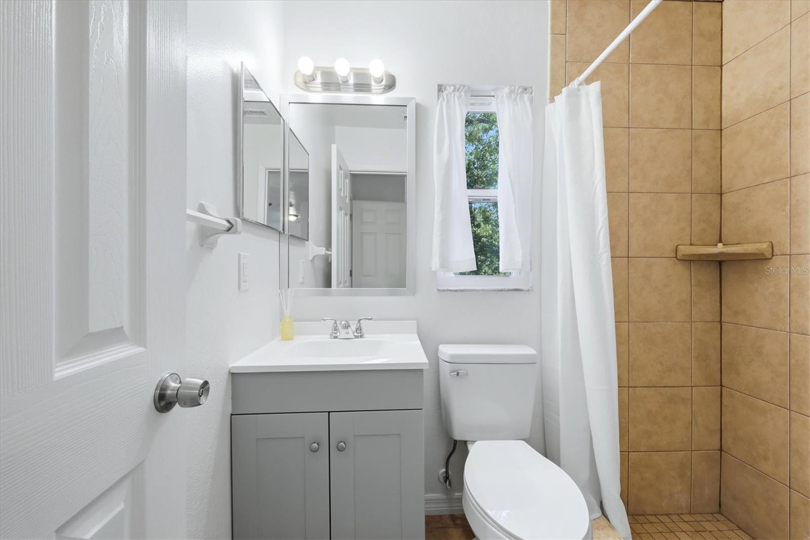 Primary bathroom has a step in shower.