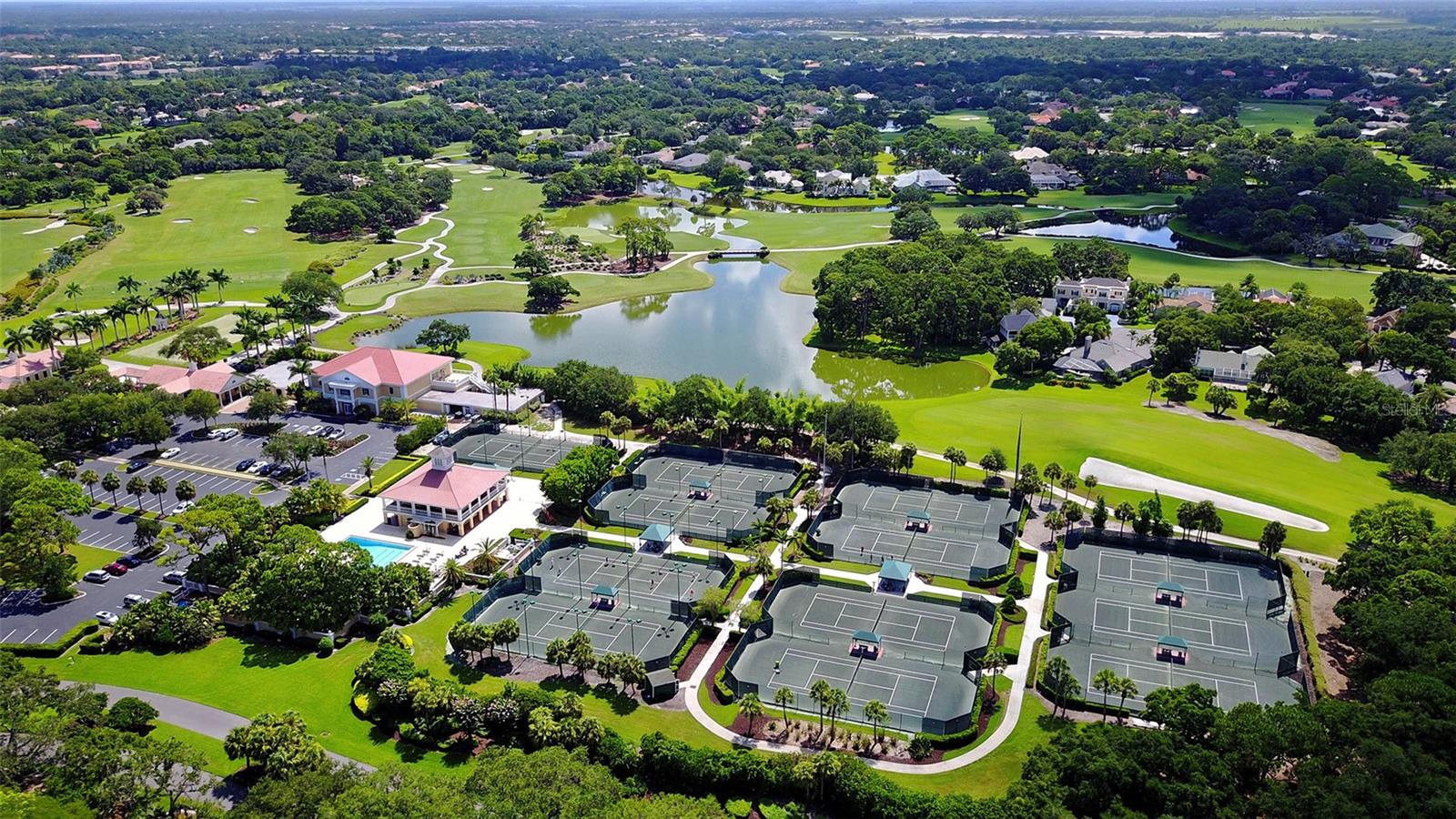 An aerial perspective highlights the expansive golf, lake and residential setting of this renowned private community.