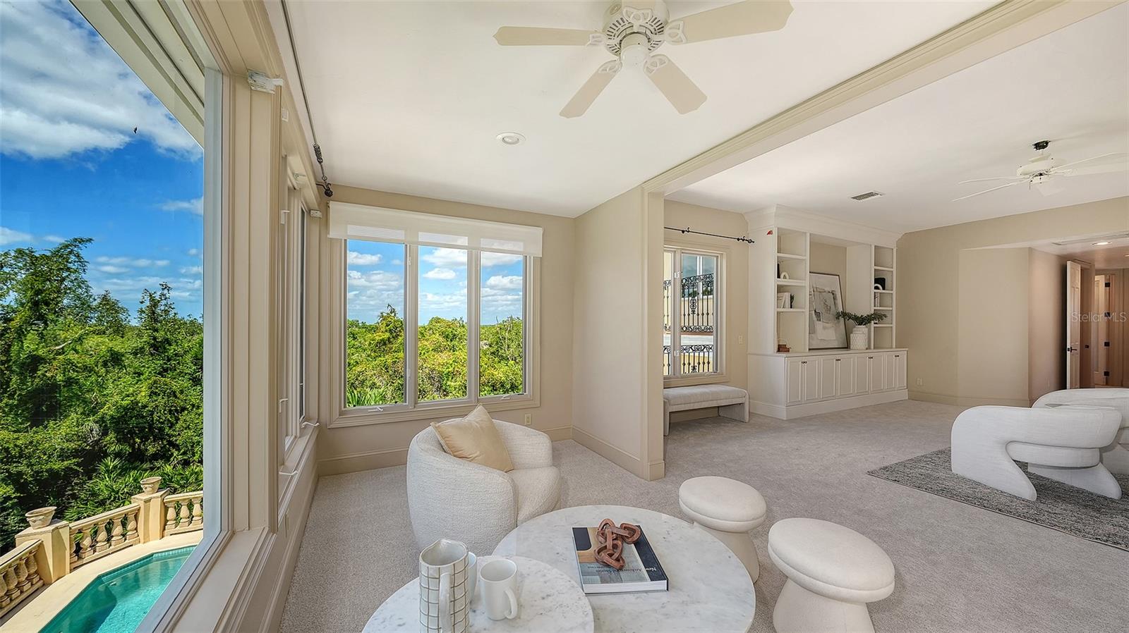 Large windows capture treetop and pool views while filling the primary retreat with beautiful natural light.