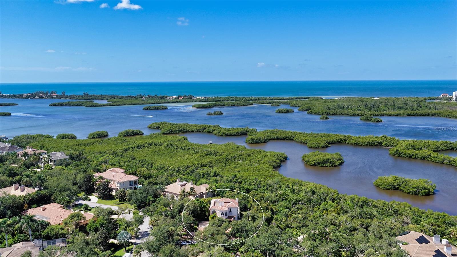 Sweeping aerial views showcase the extraordinary natural setting along Little Sarasota Bay and the surrounding coastal landscape.