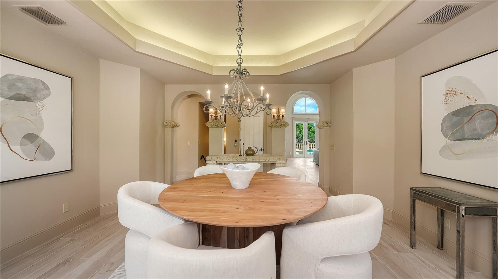 The dining room's graceful proportions and architectural detailing create an inviting space for memorable gatherings.