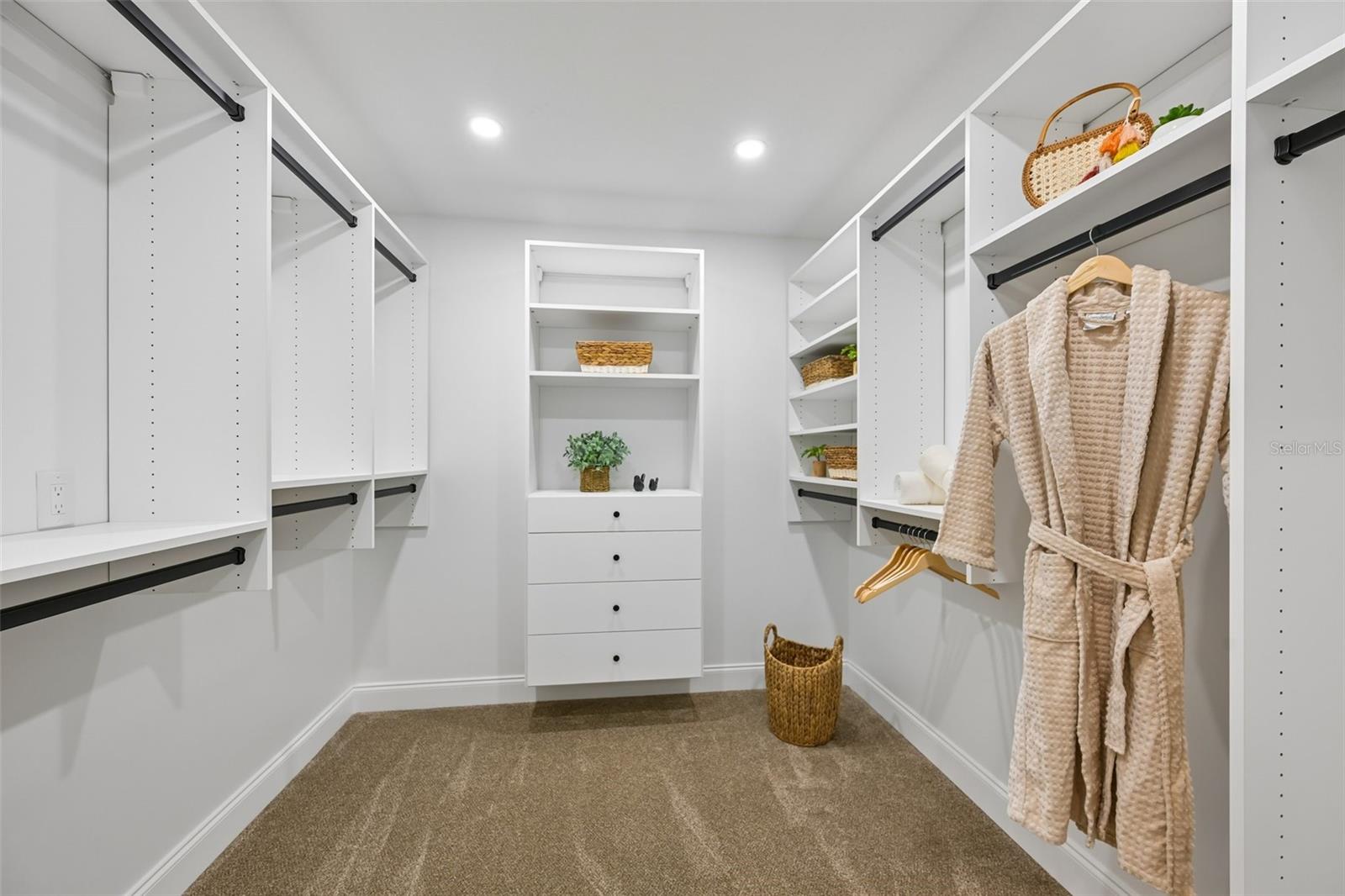 1st walk-in closet with California Closet system in the primary suite