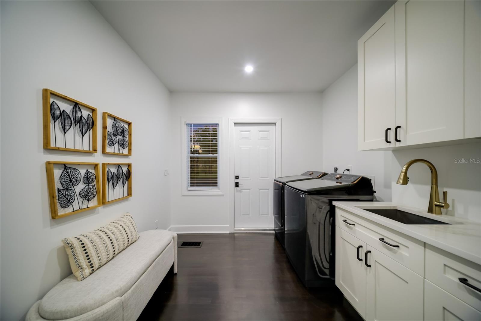 The perfect laundry room with access the the back yard, and garage.