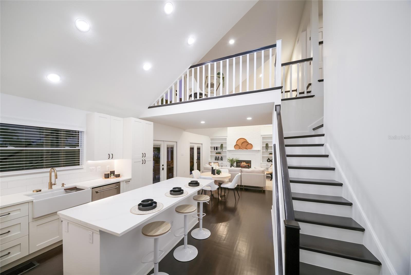 Access to the upstairs loft, deck, and addtional bedrooms off the kitchen.