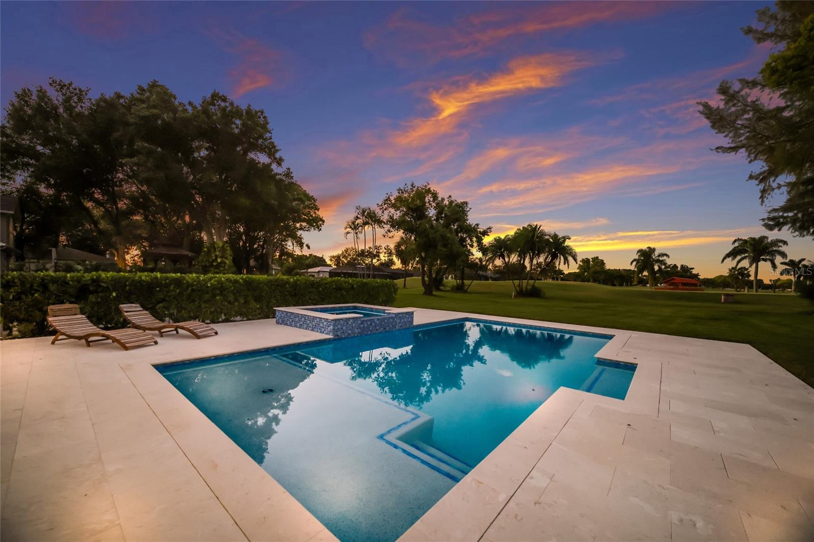 Spacious pool deck with large custom salt water pool and spa.