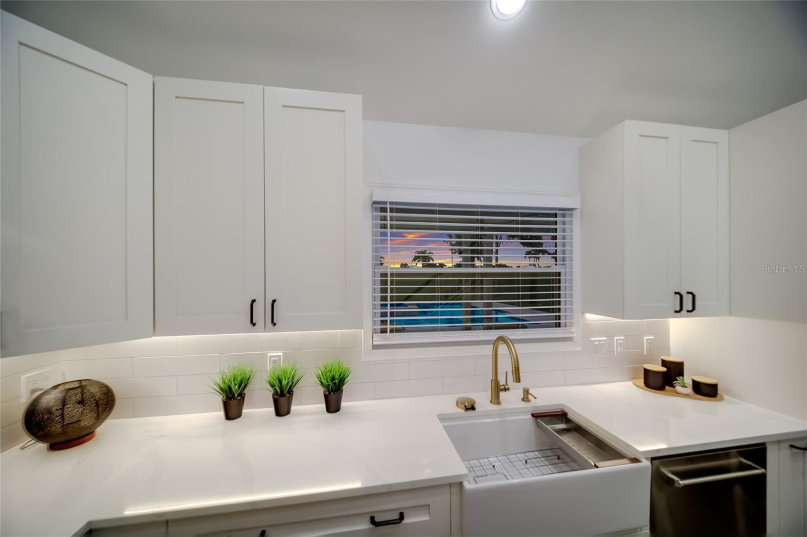 Deep farmhouse sink beneath the window.
