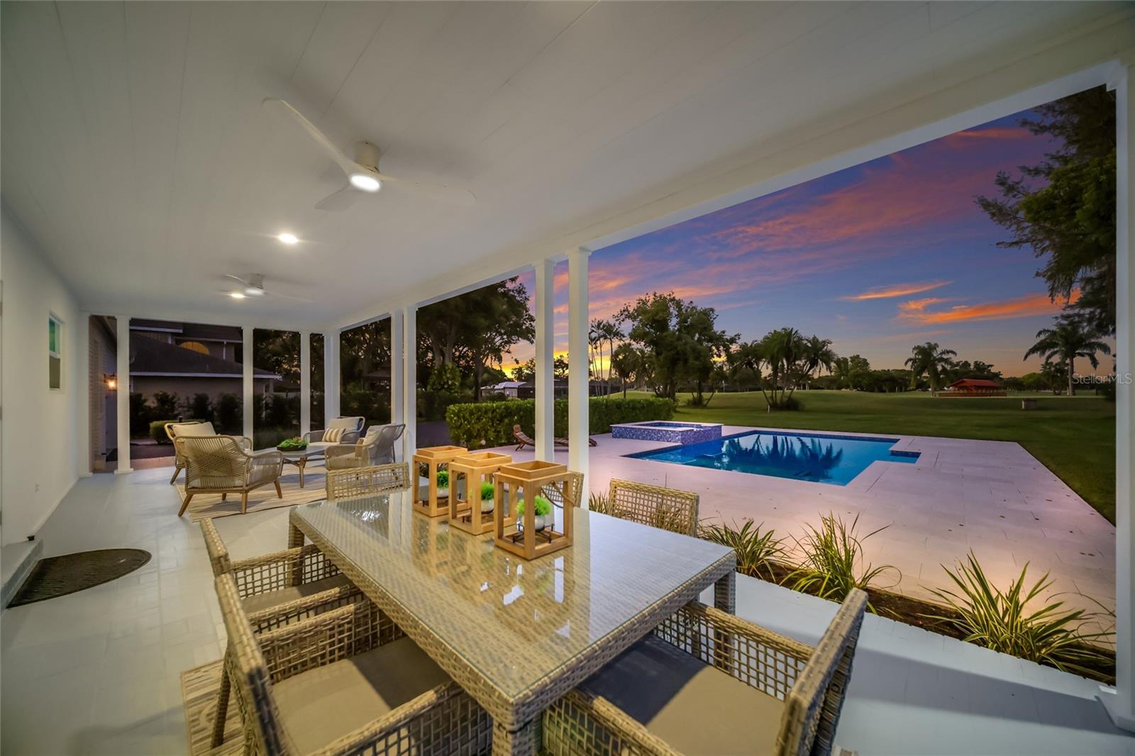 Back porch overlooks the pool and golf course. Back porch overlooks the pool and golf course.