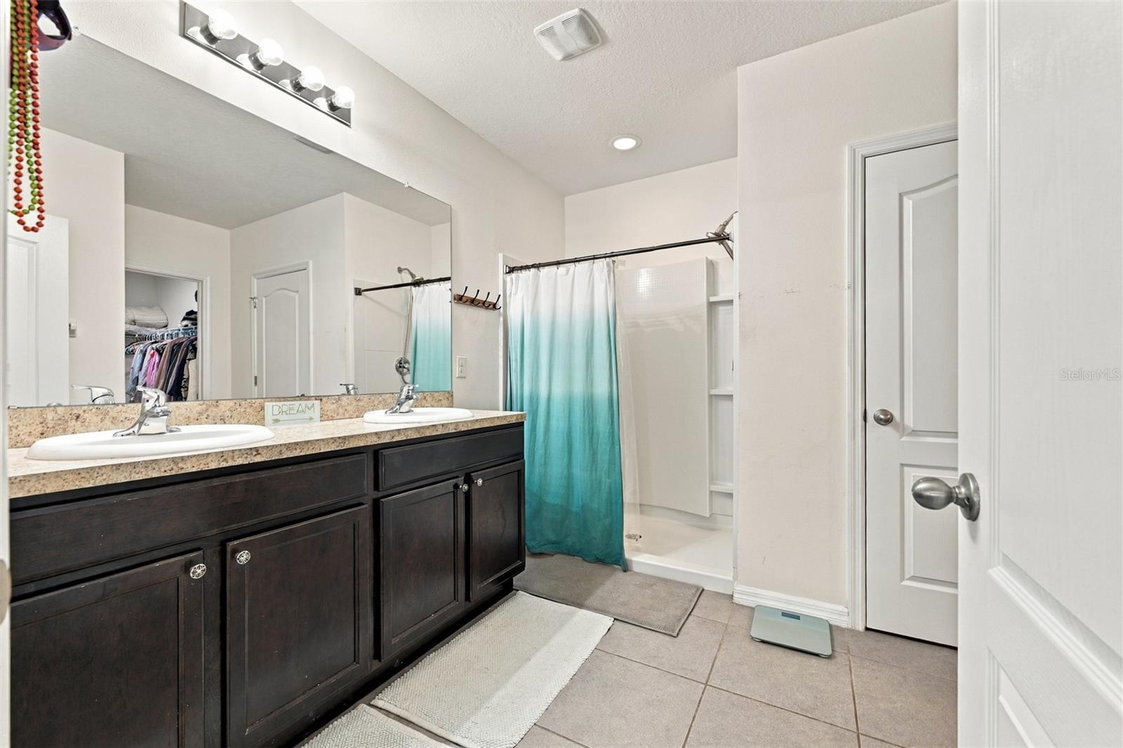Primary bathroom with shower and 2-closets